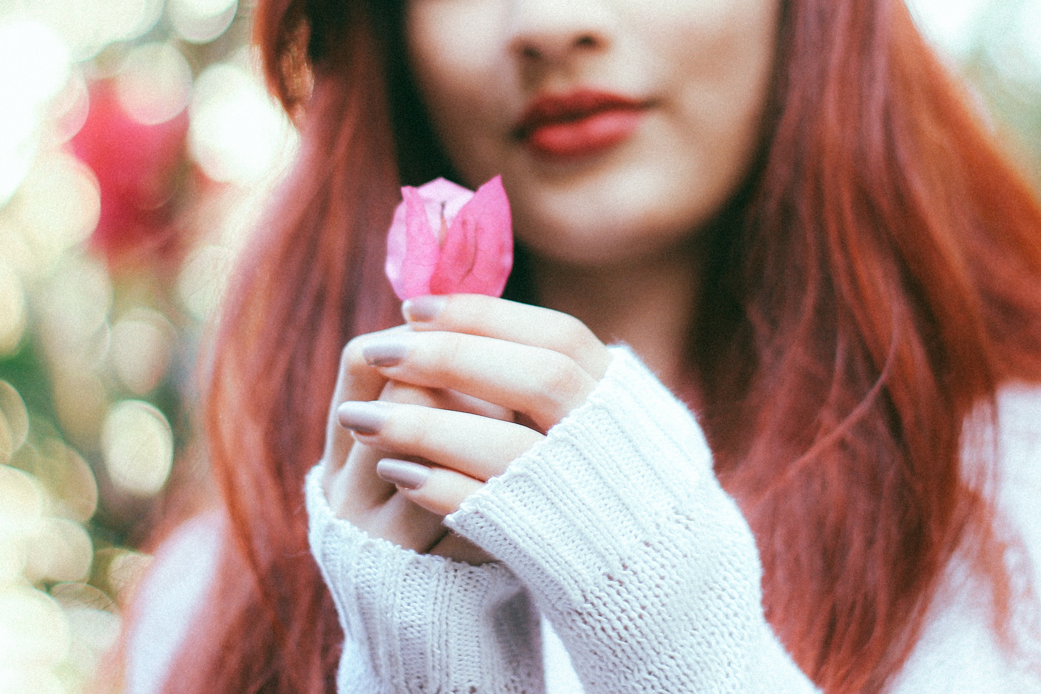 Woman with red hair holding a pink flower HD Wallpaper