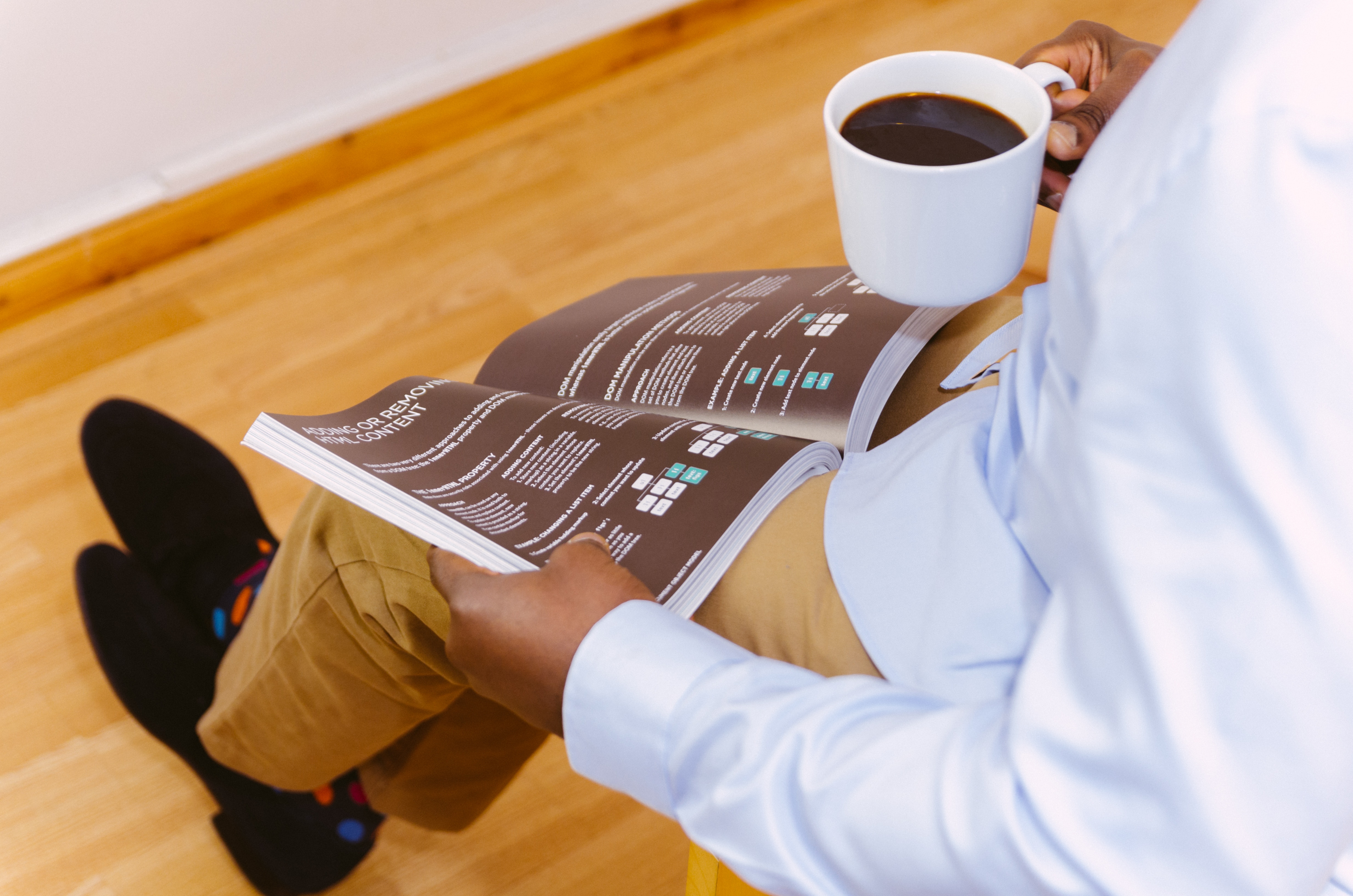 Man reading a magazine and drinking coffee HD Wallpaper