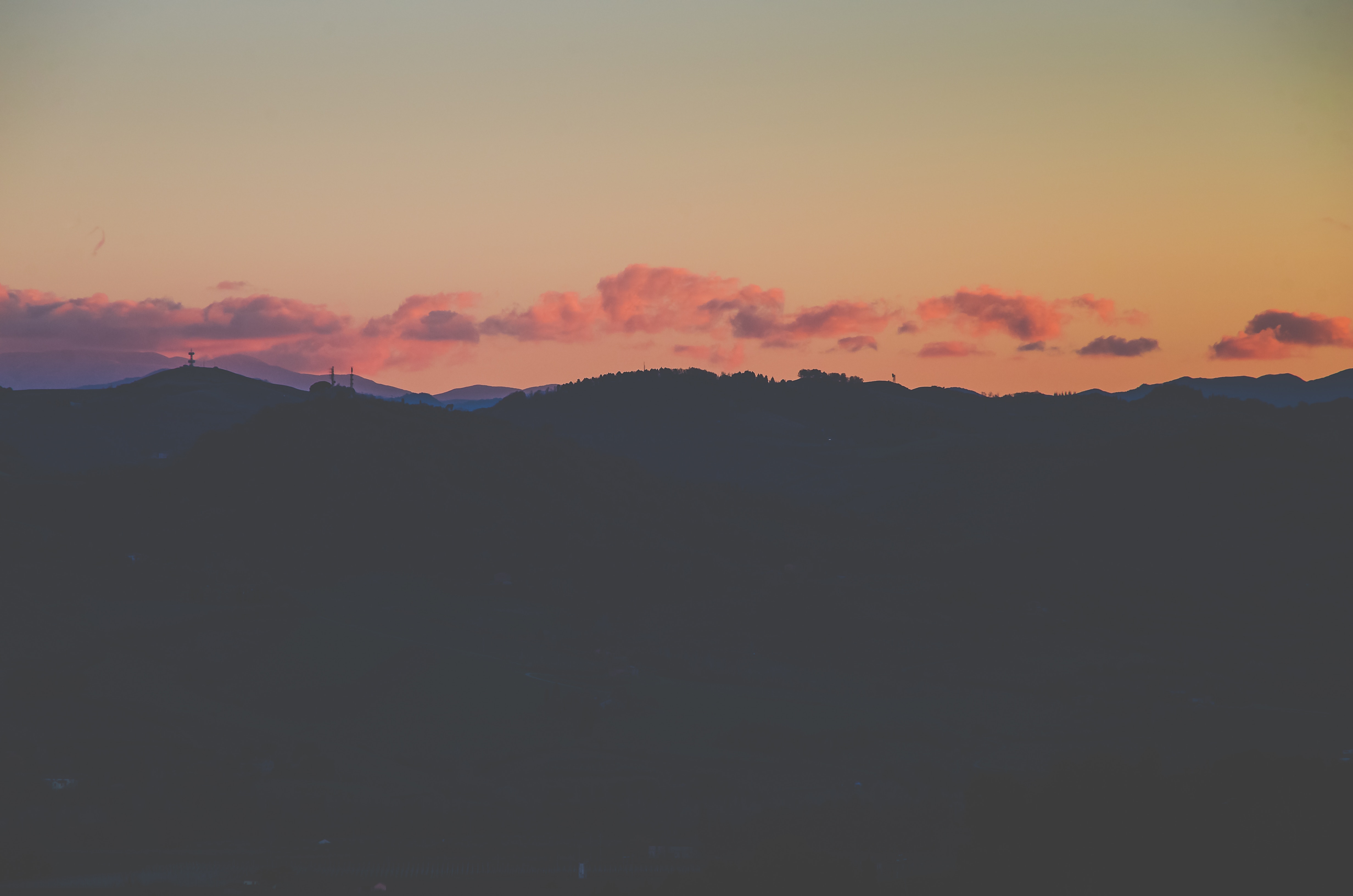 Silhouette of mountains at sunset with pink clouds HD Wallpaper