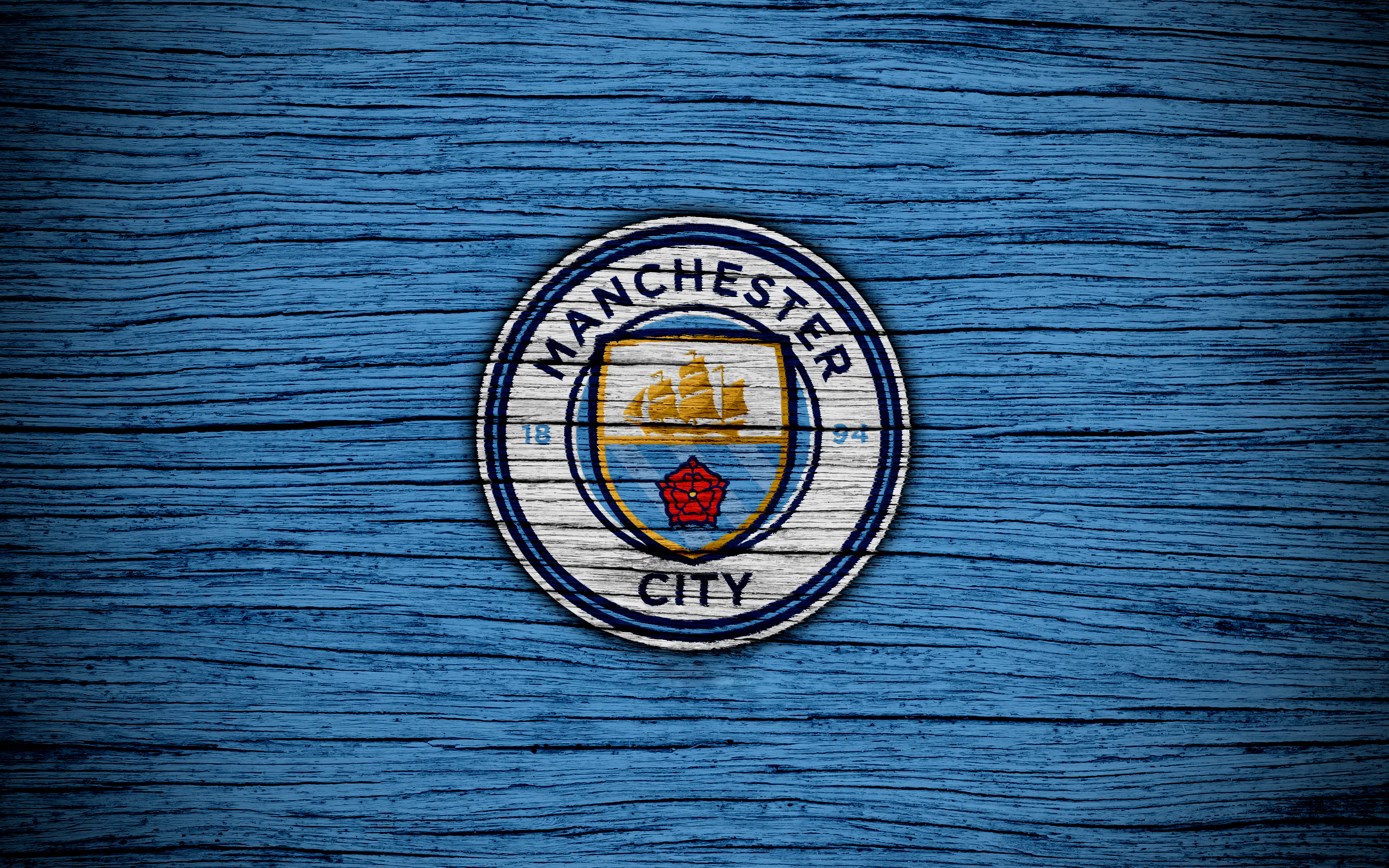 Manchester City F.C. logo on blue wooden background HD Wallpaper