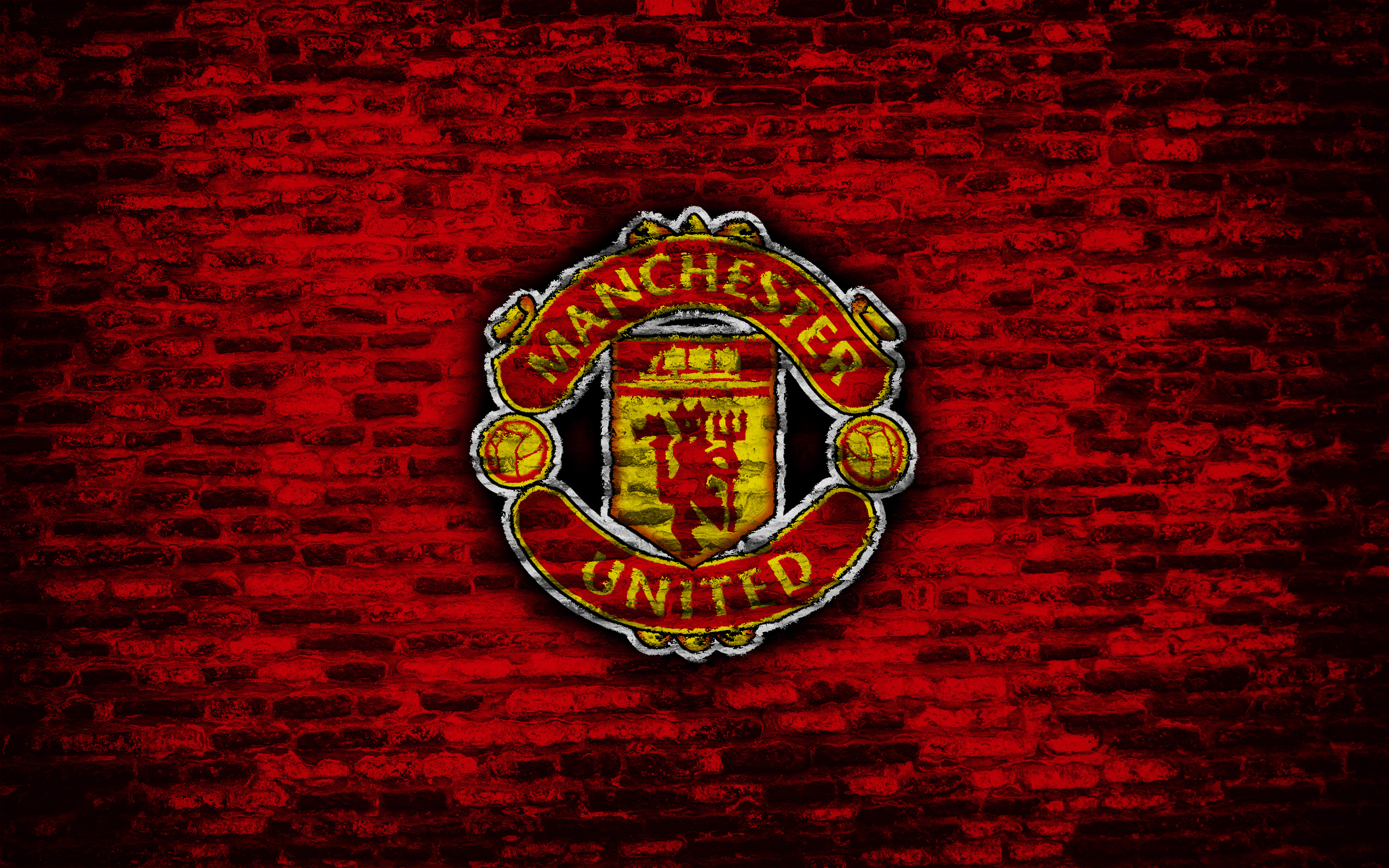 Manchester United F.C. logo on red brick background HD Wallpaper