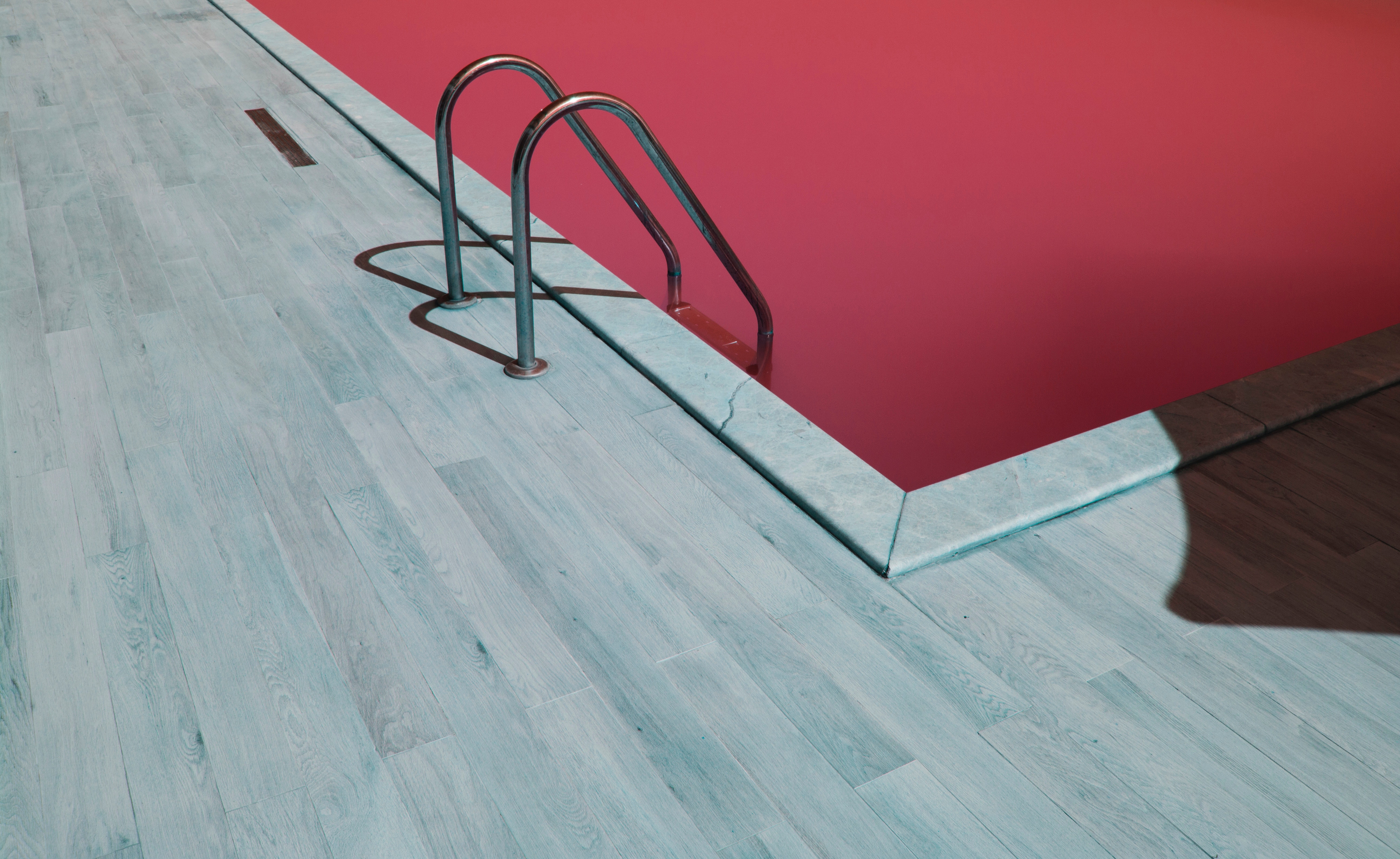 Red pool with a ladder and wooden deck HD Wallpaper