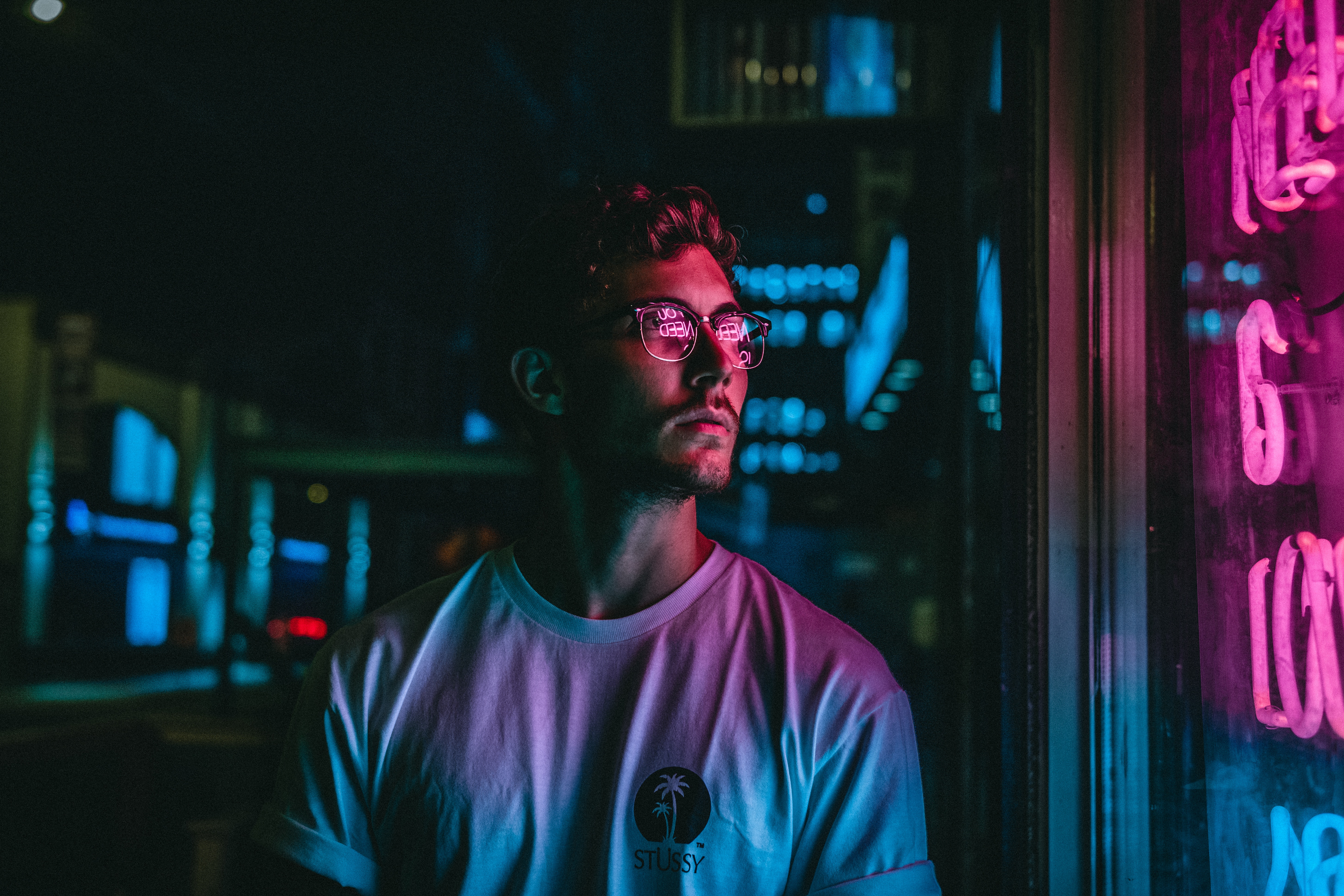 Man wearing glasses in front of neon lights HD Wallpaper