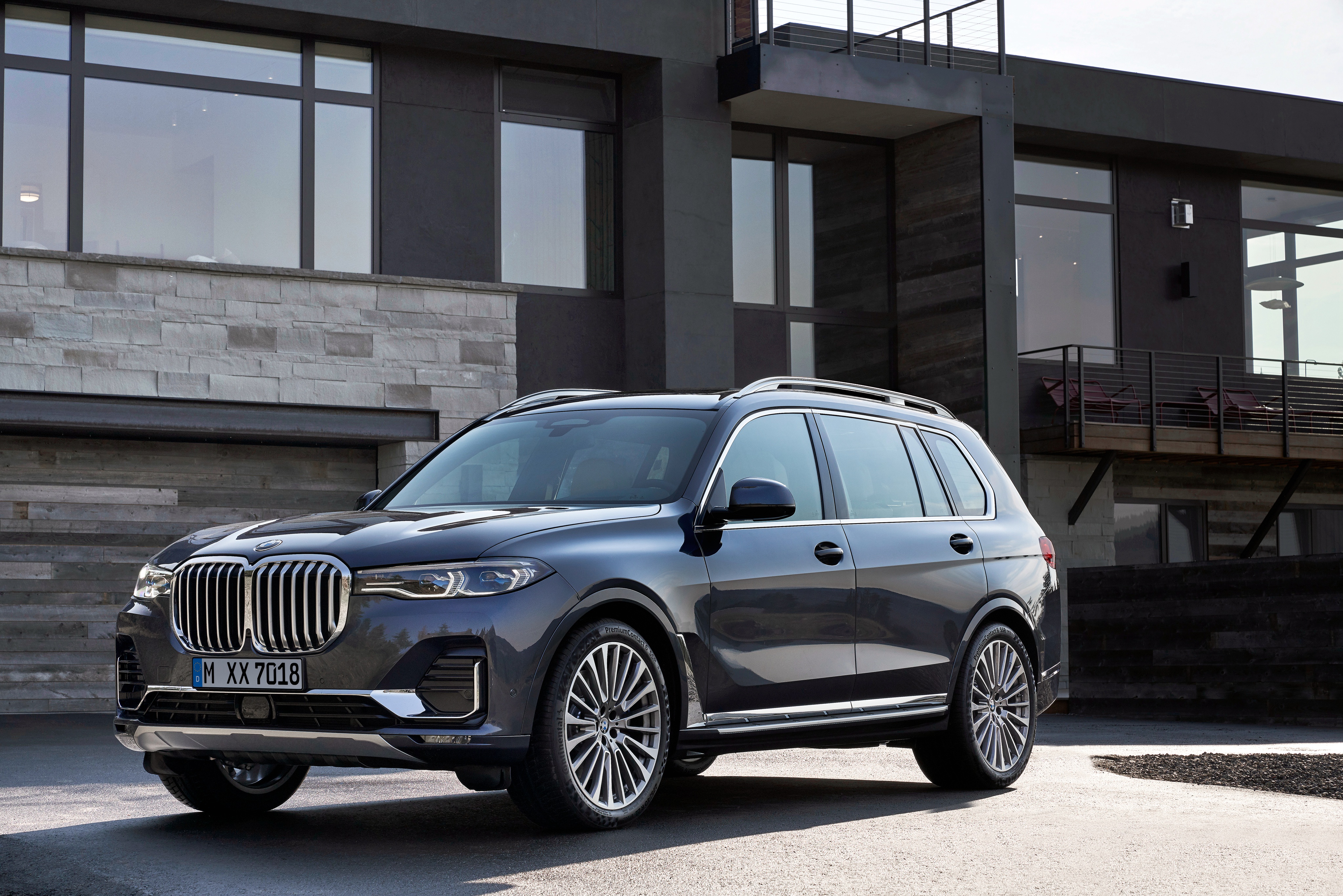 BMW X7 SUV parked in front of a modern house HD Wallpaper
