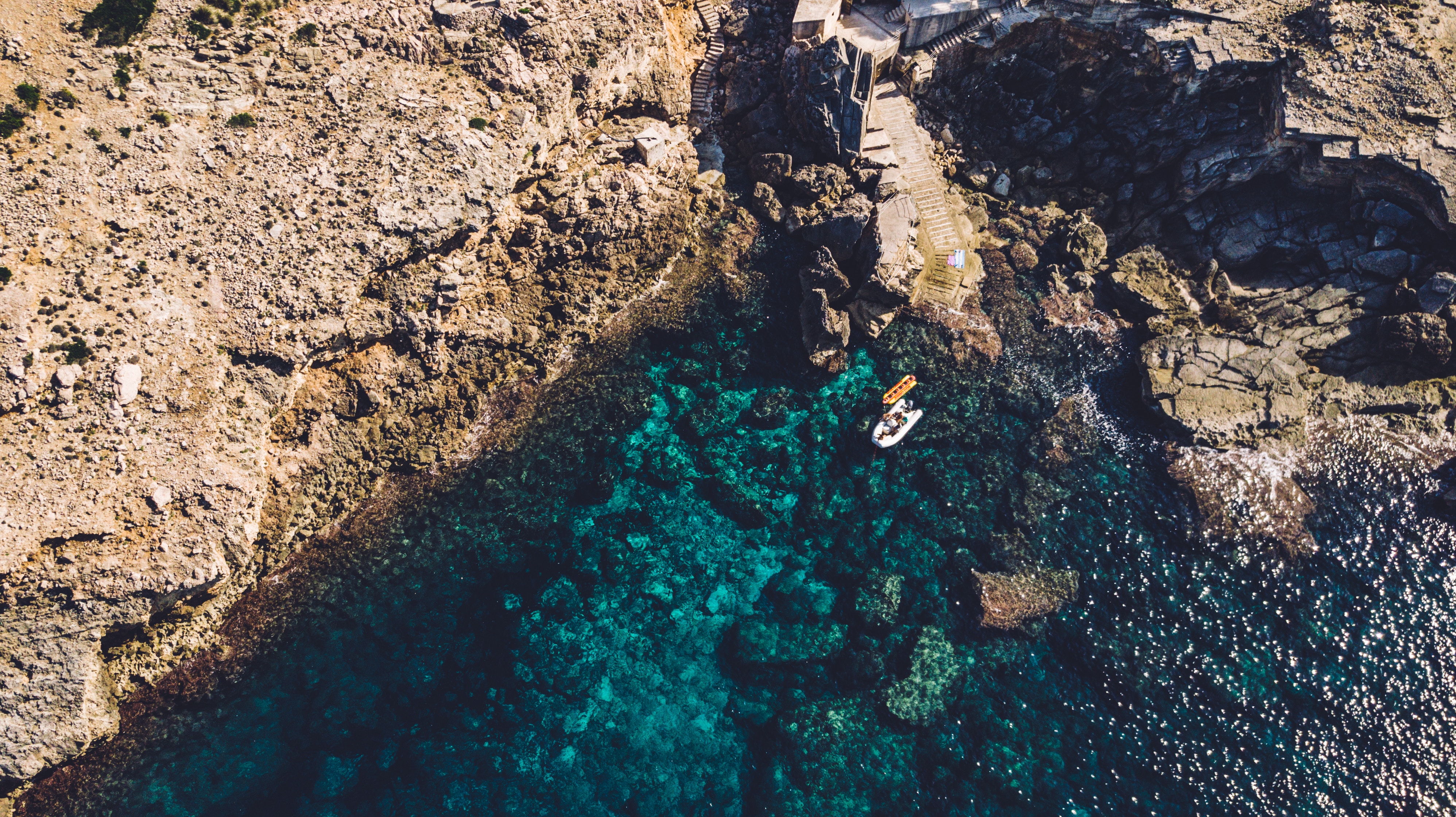 Boat near rocky coast of Mallorca, Spain HD Wallpaper