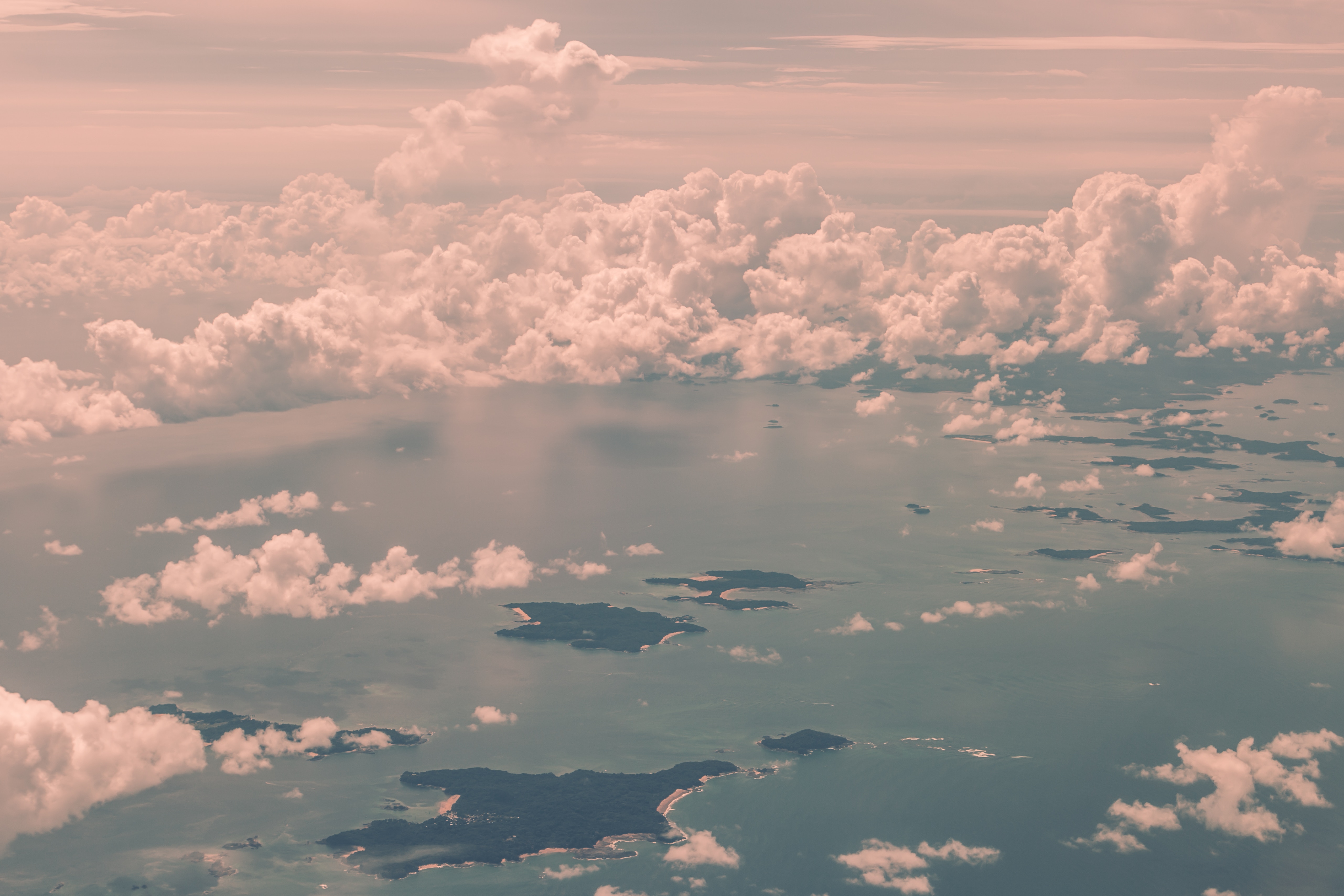 Aerial view of islands in the sea under pink clouds HD Wallpaper