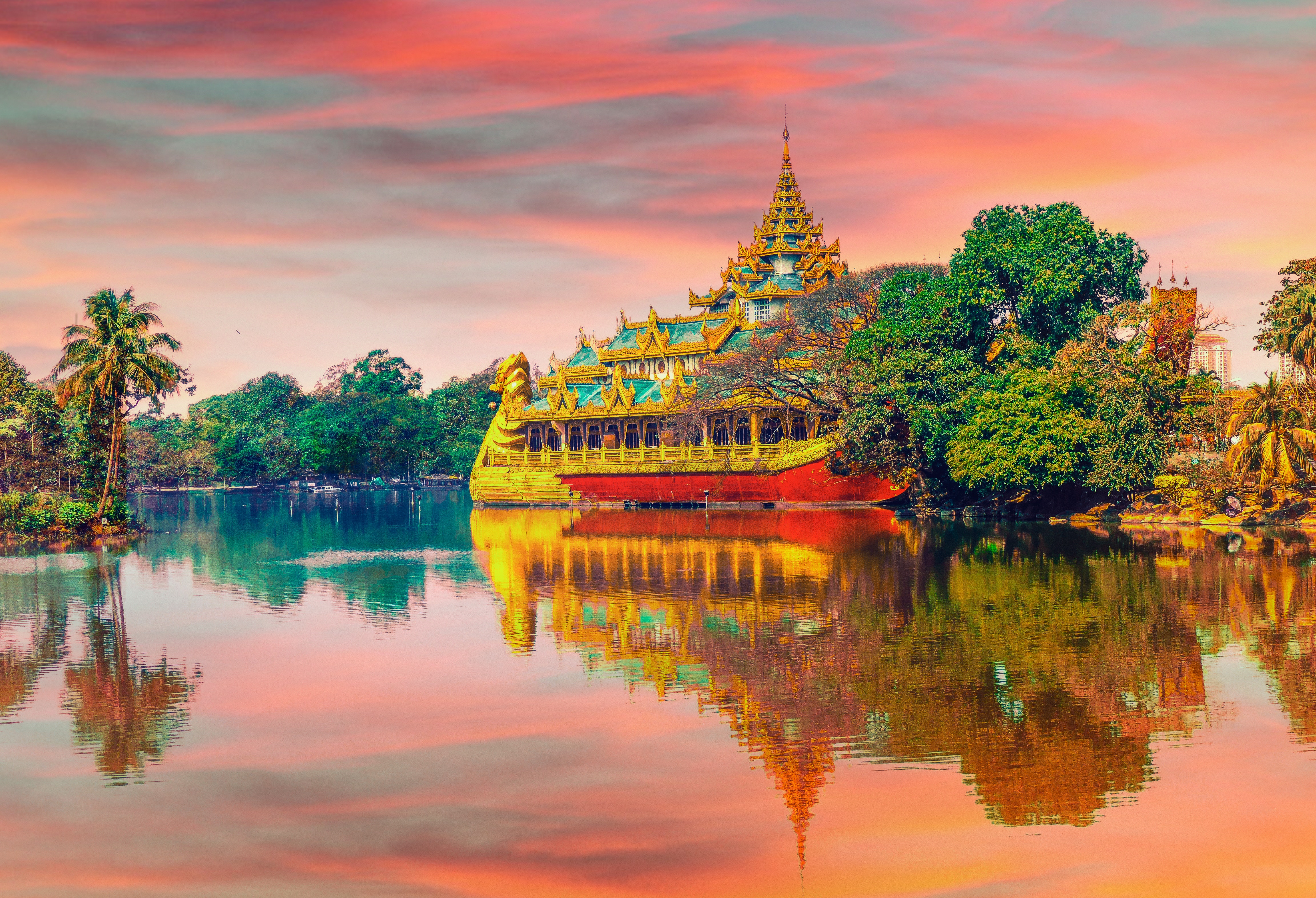 Golden Buddhist barge on a lake at sunset HD Wallpaper