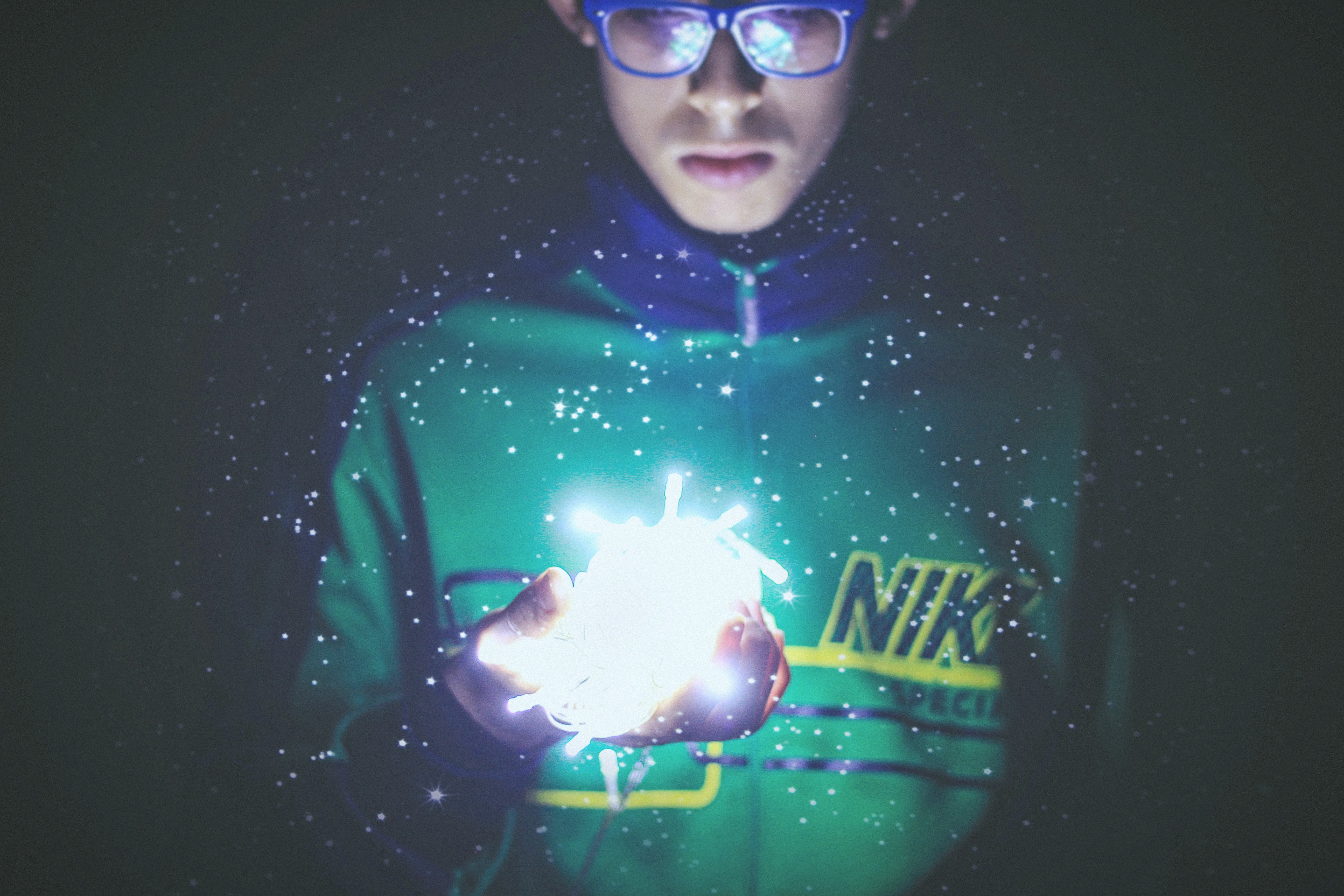 Boy in Nike jacket holding glowing fairy lights HD Wallpaper