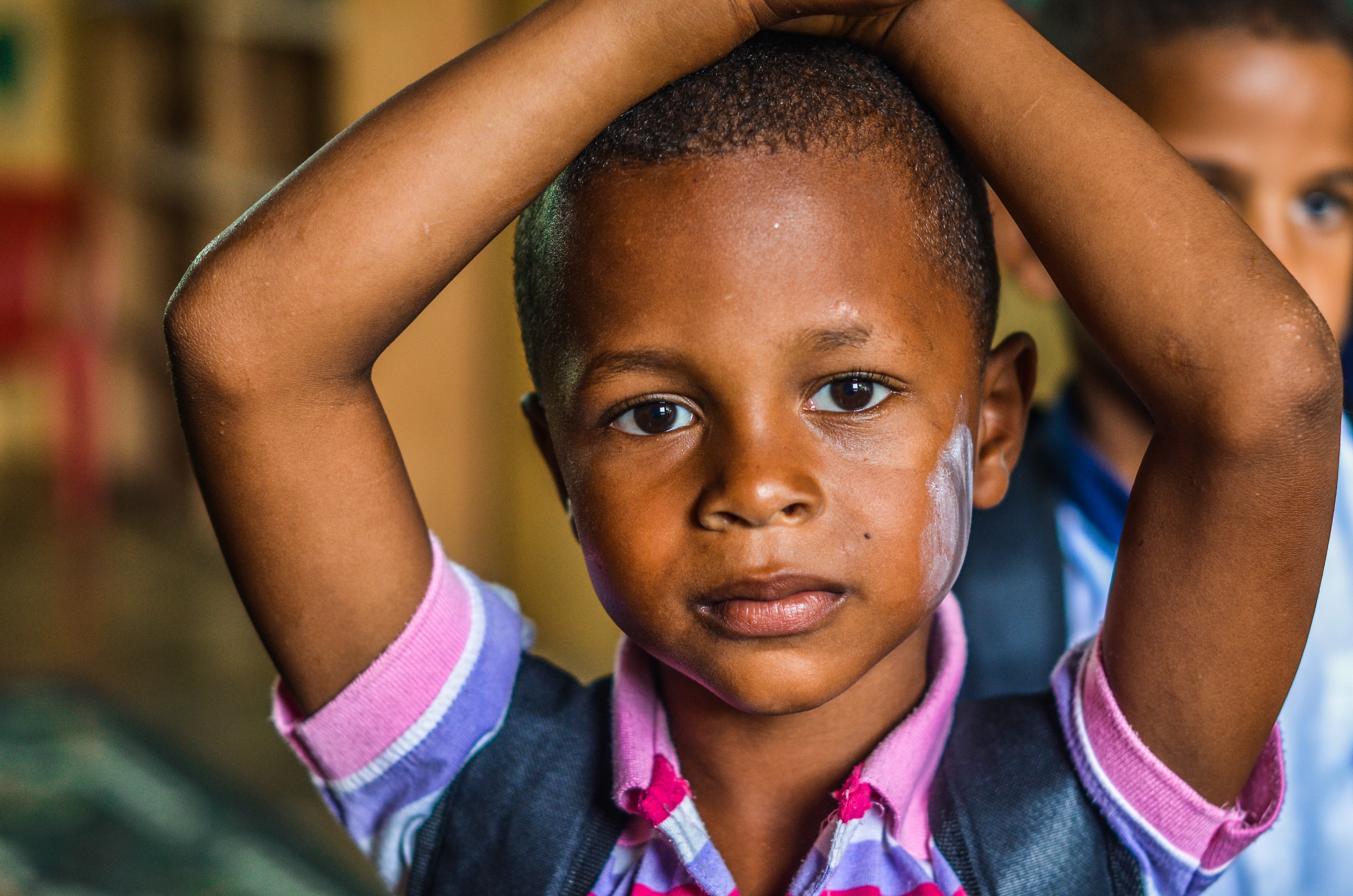 Boy with hands on head in school HD Wallpaper