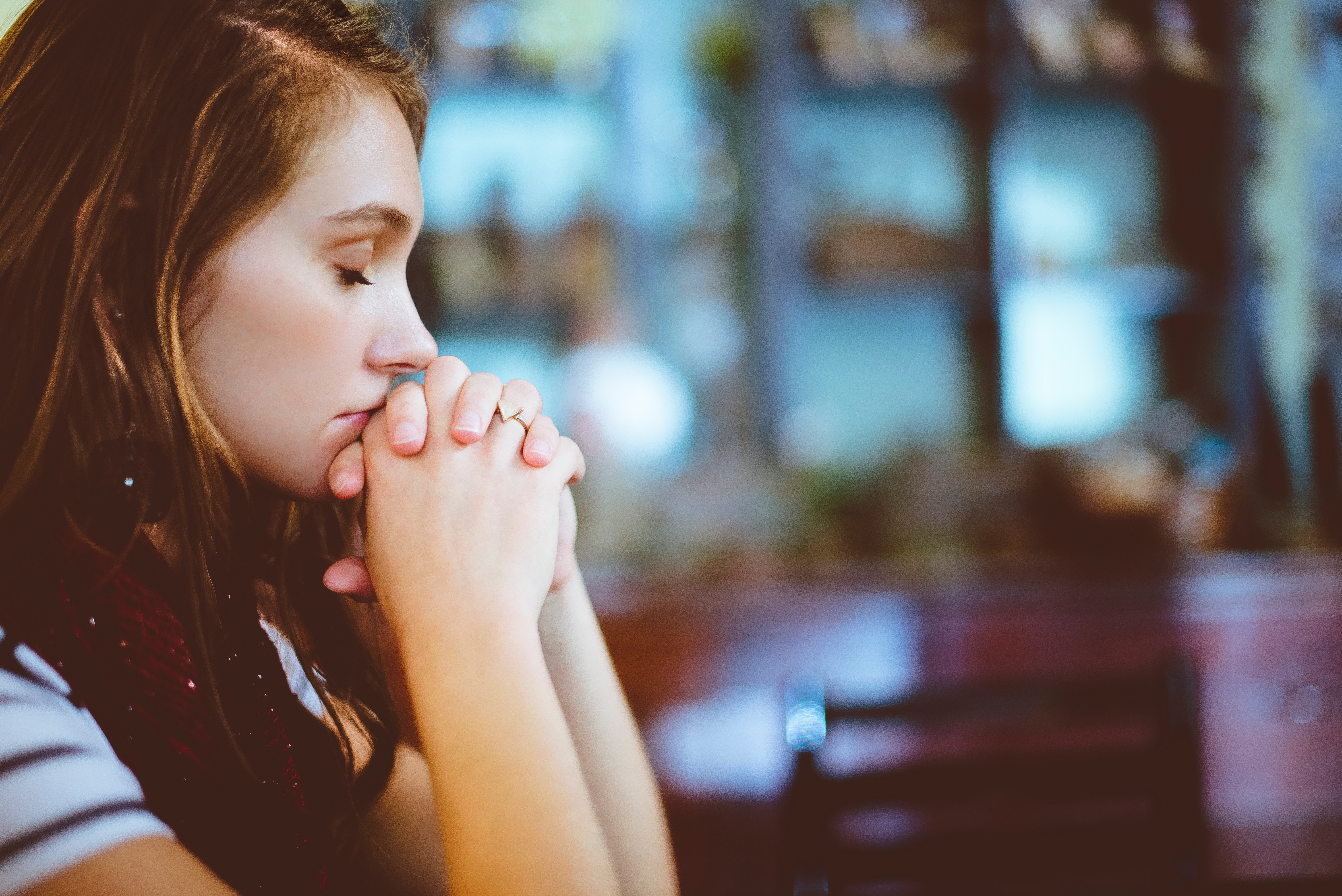 Woman praying with hands clasped HD Wallpaper