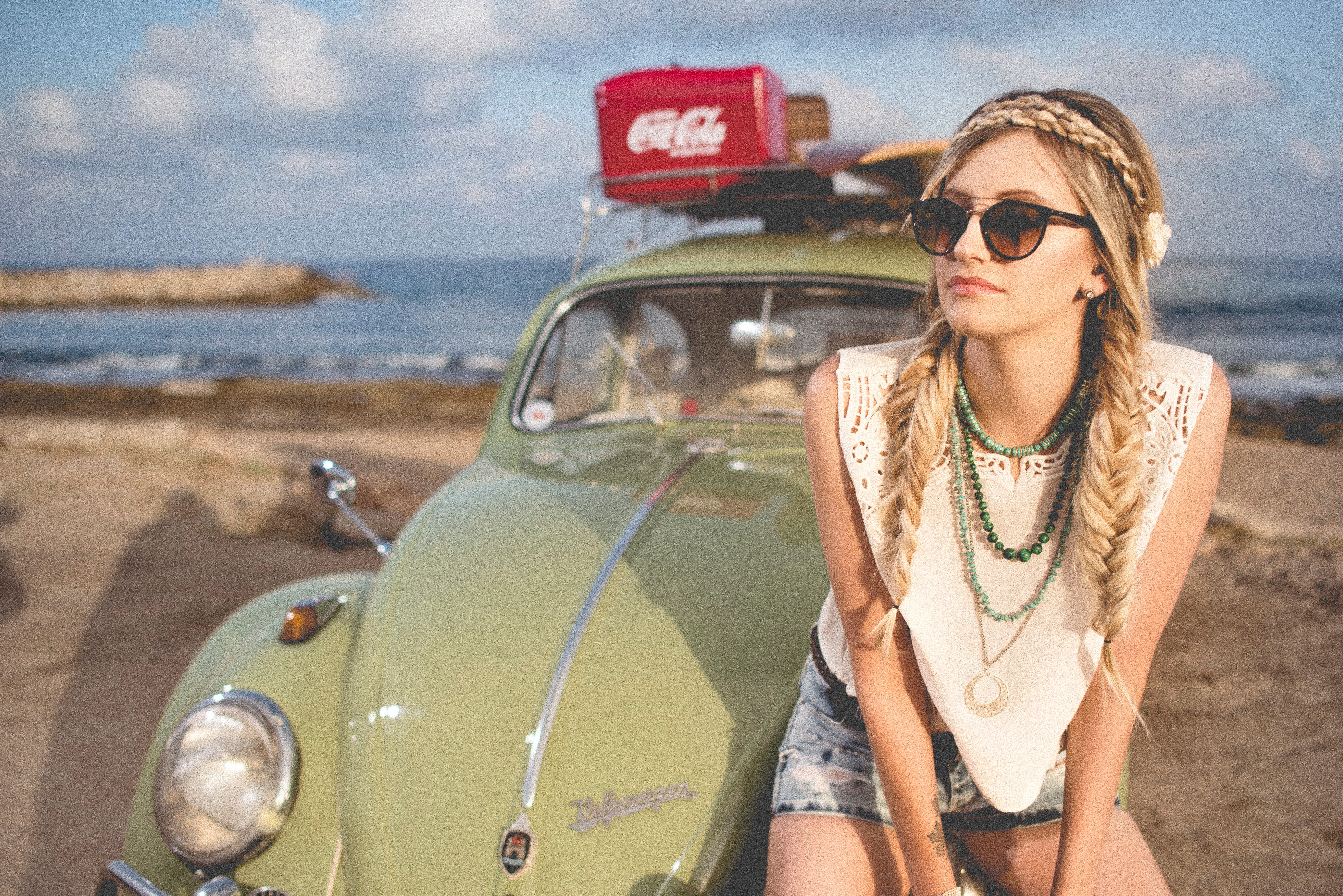 Woman with braids and sunglasses by a vintage VW Beetle HD Wallpaper
