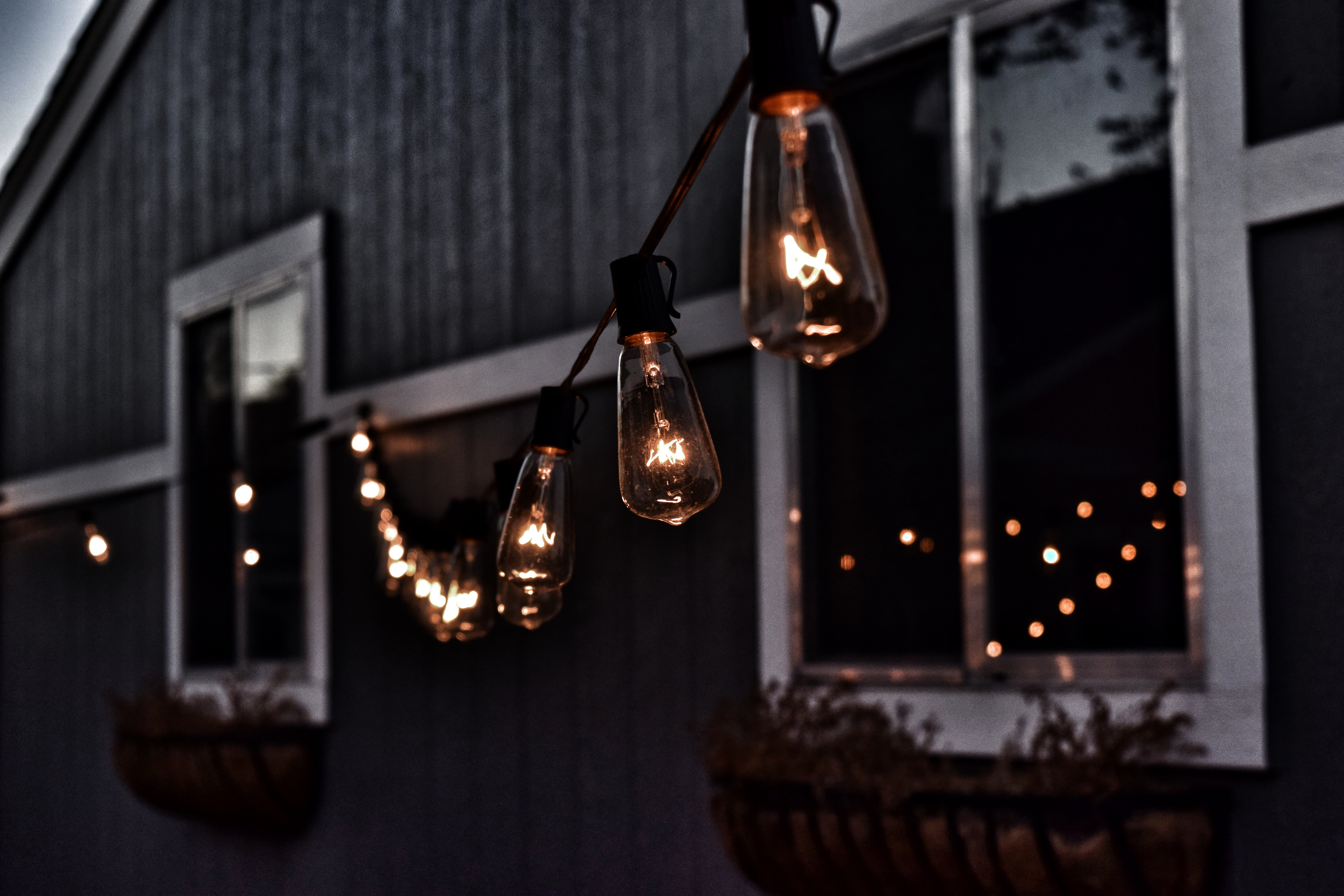 String lights illuminate a dark shed with windows HD Wallpaper