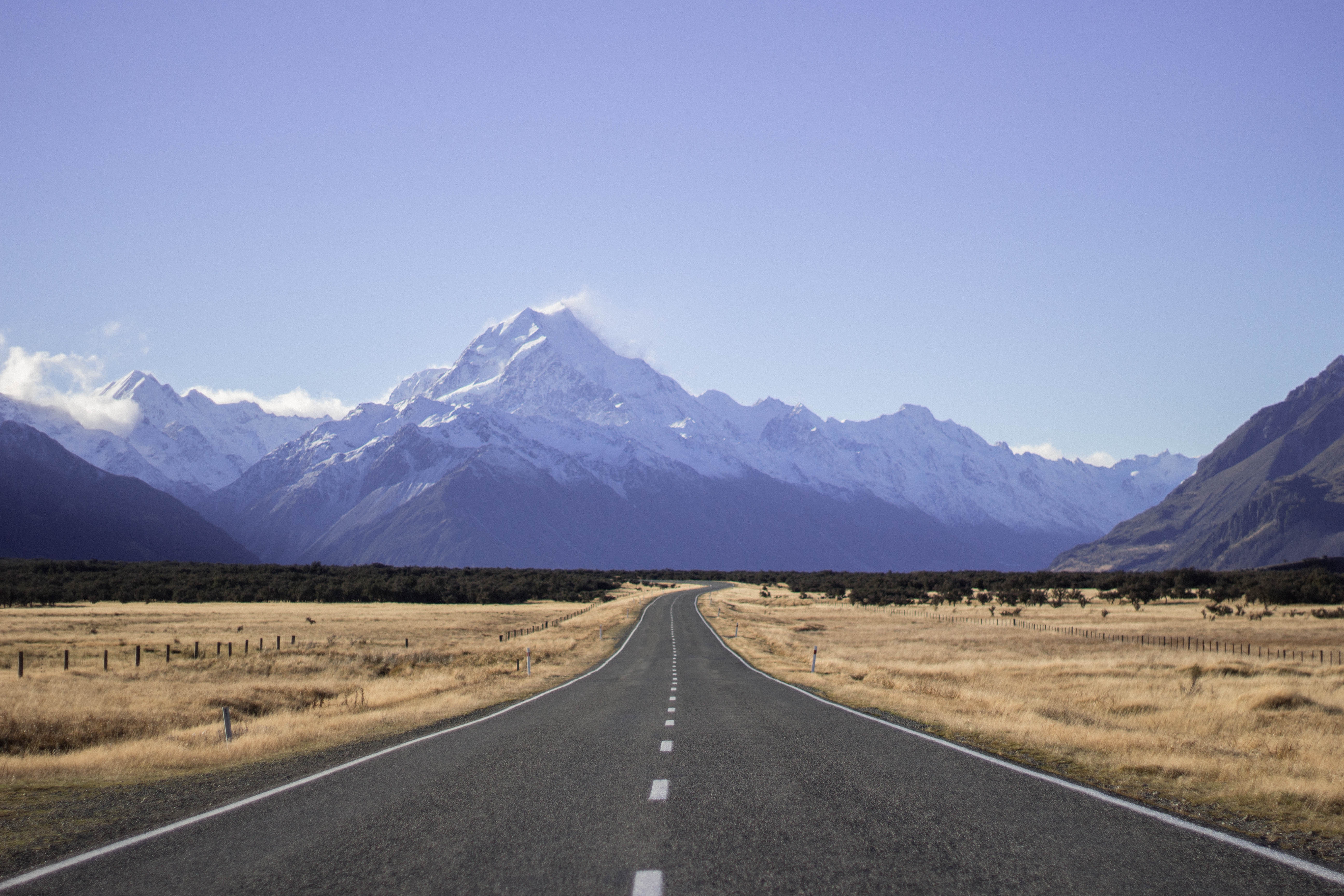 Straight Road Leading to Snow-Capped Mountains in New Zealand HD Wallpaper