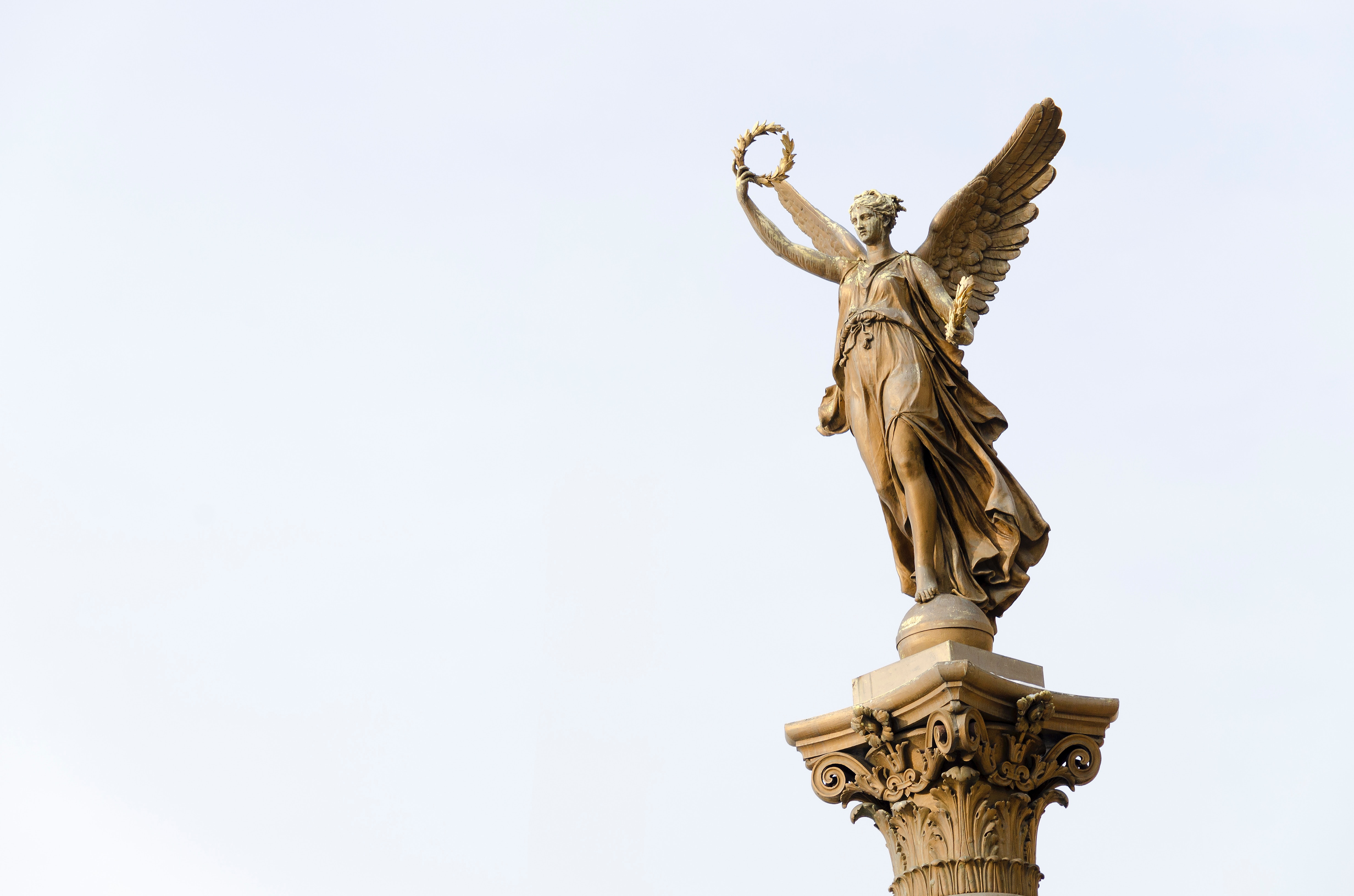 Angel statue holding a laurel wreath on a column HD Wallpaper