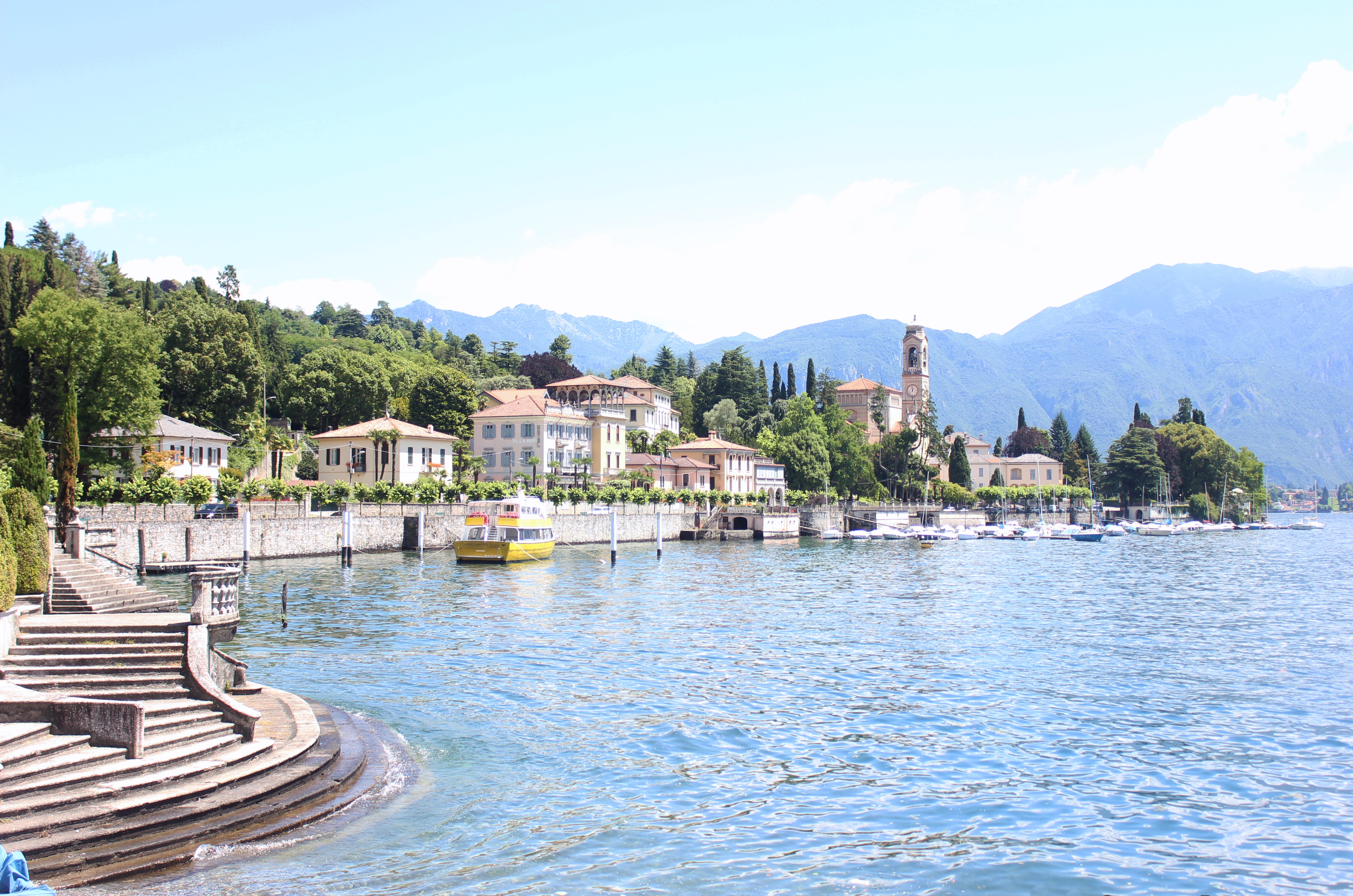 Lake Como village with mountains and a yellow boat HD Wallpaper