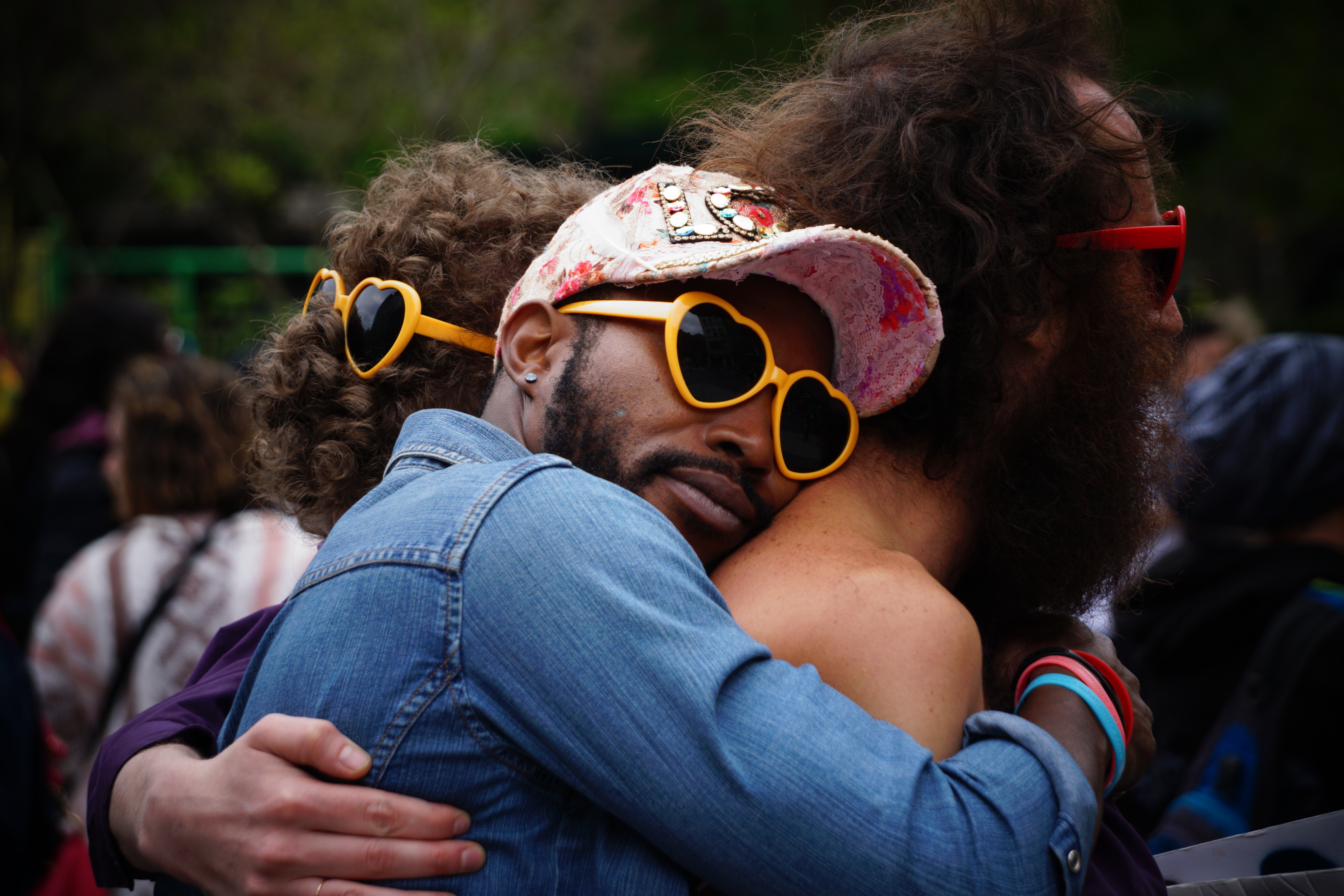 Two men hugging, wearing heart-shaped sunglasses HD Wallpaper
