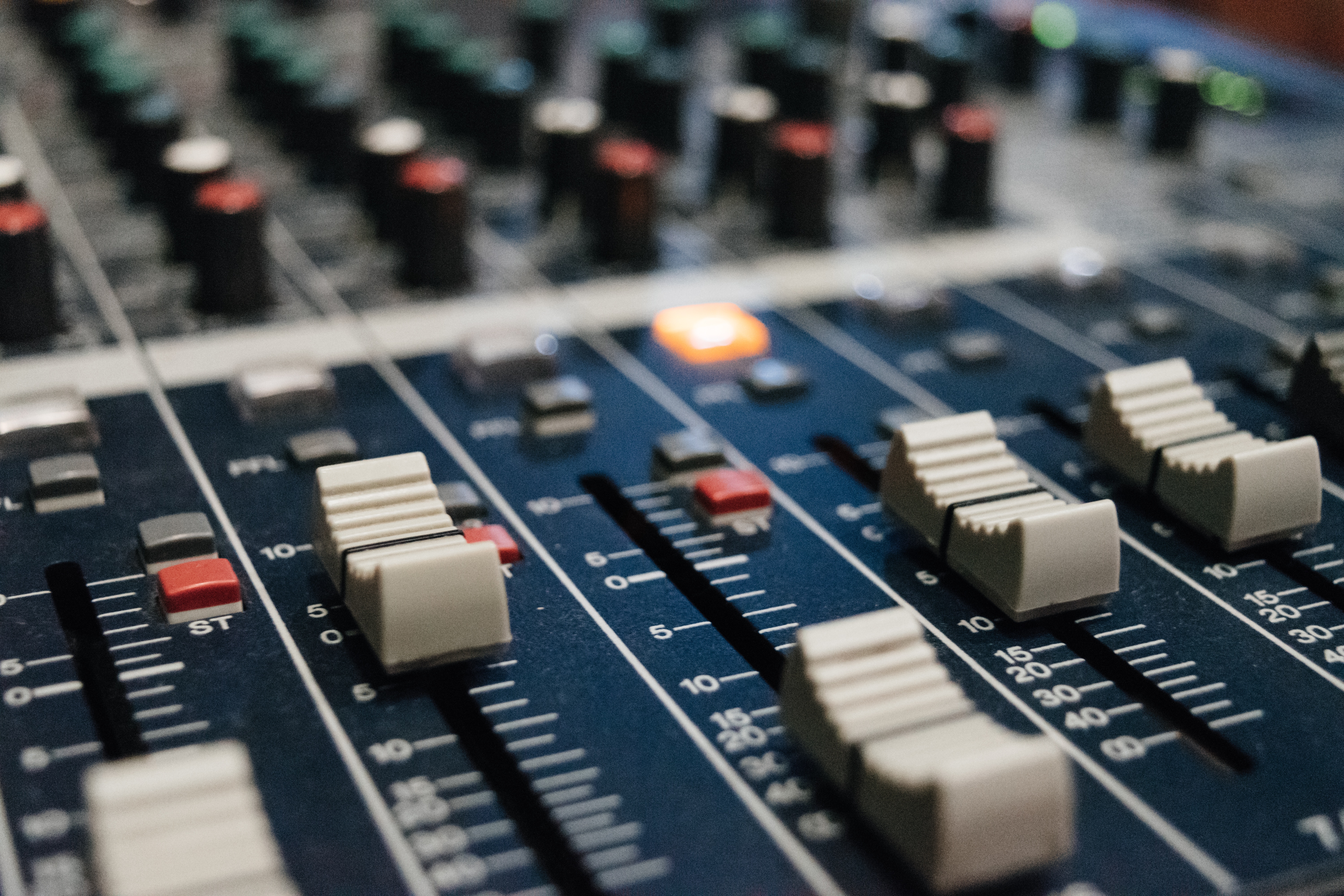 Close-up of a sound mixing board with sliders HD Wallpaper