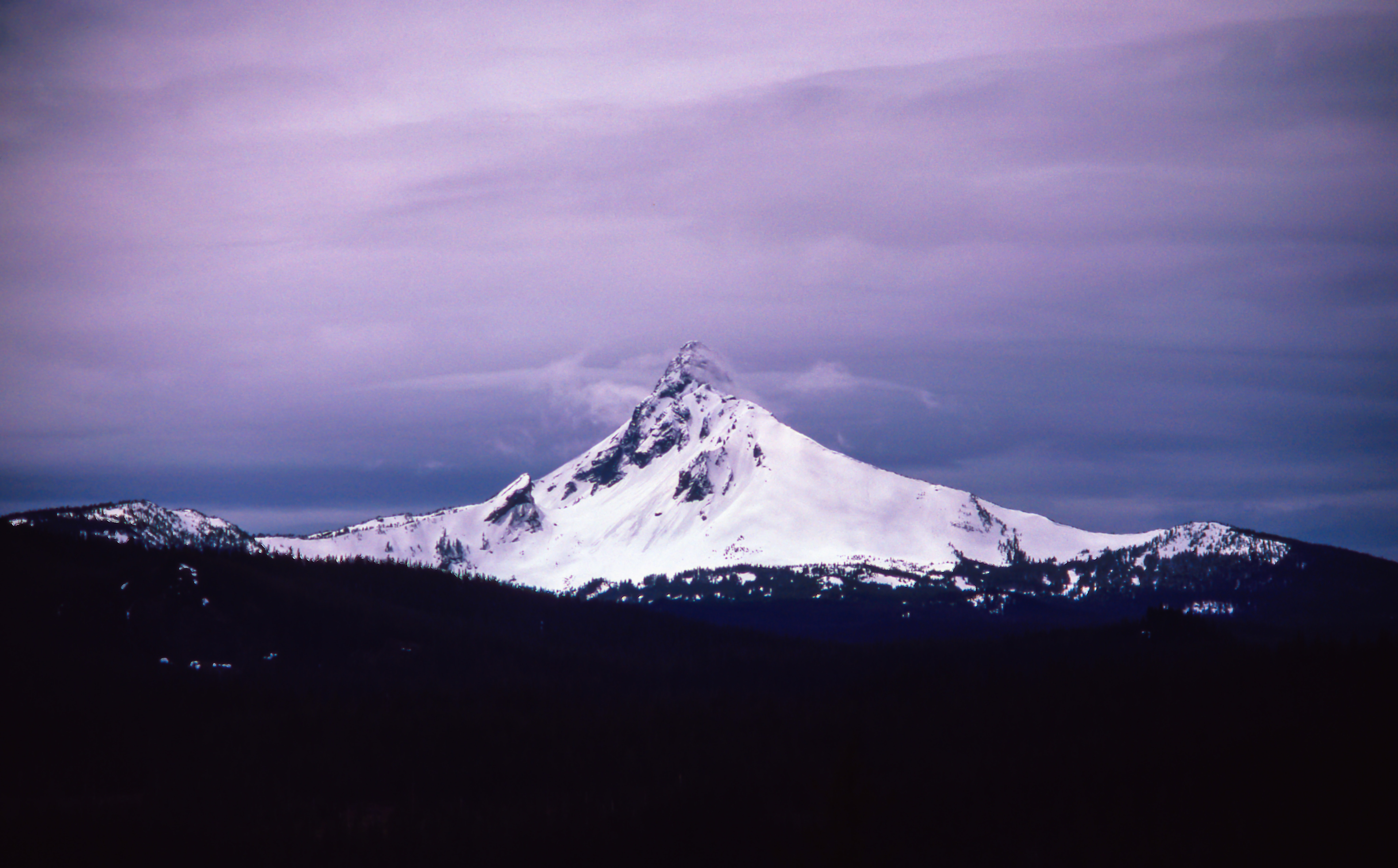 Snowcapped mountain peak under a purple sky HD Wallpaper