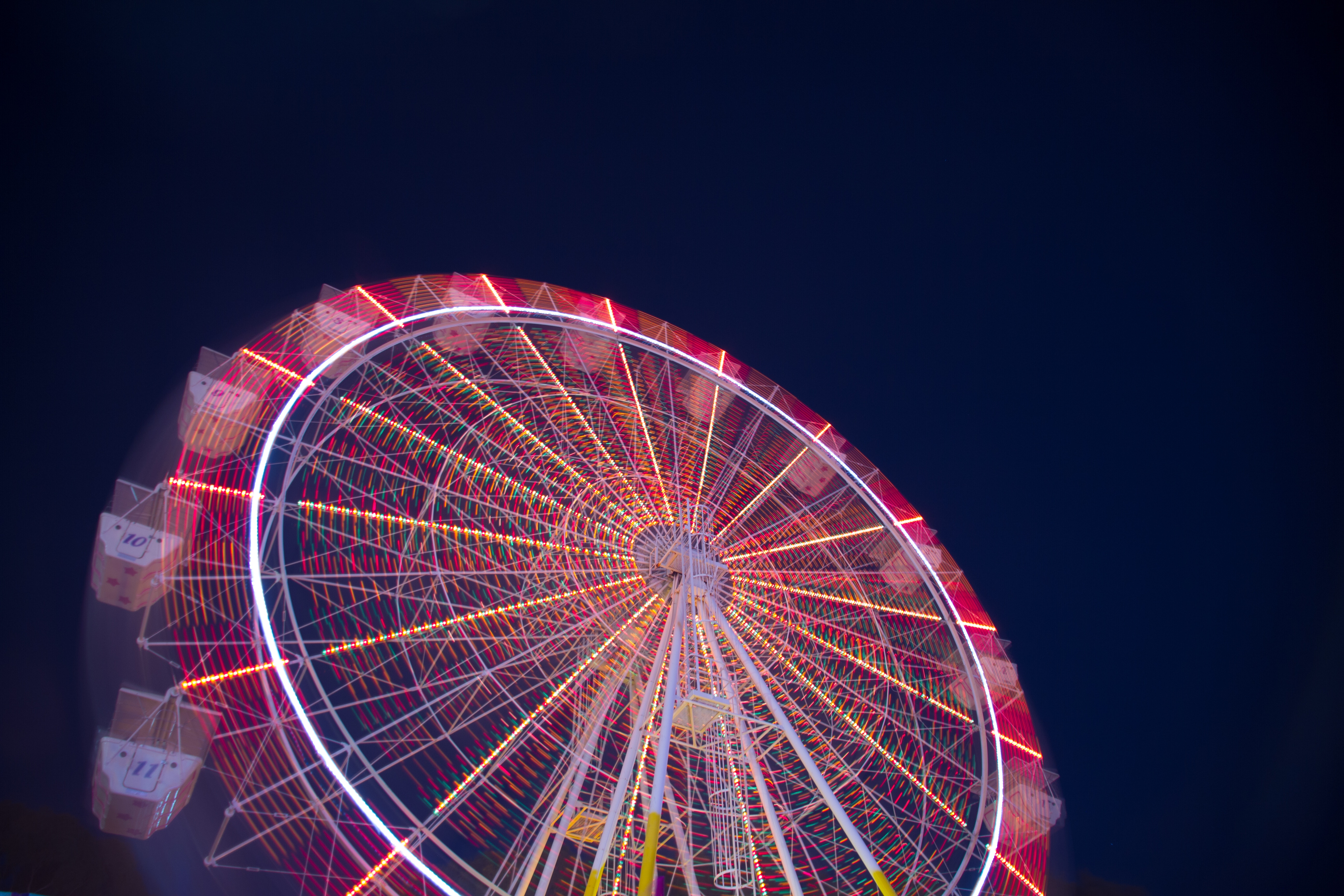 Illuminated Ferris Wheel Spinning at Night HD Wallpaper