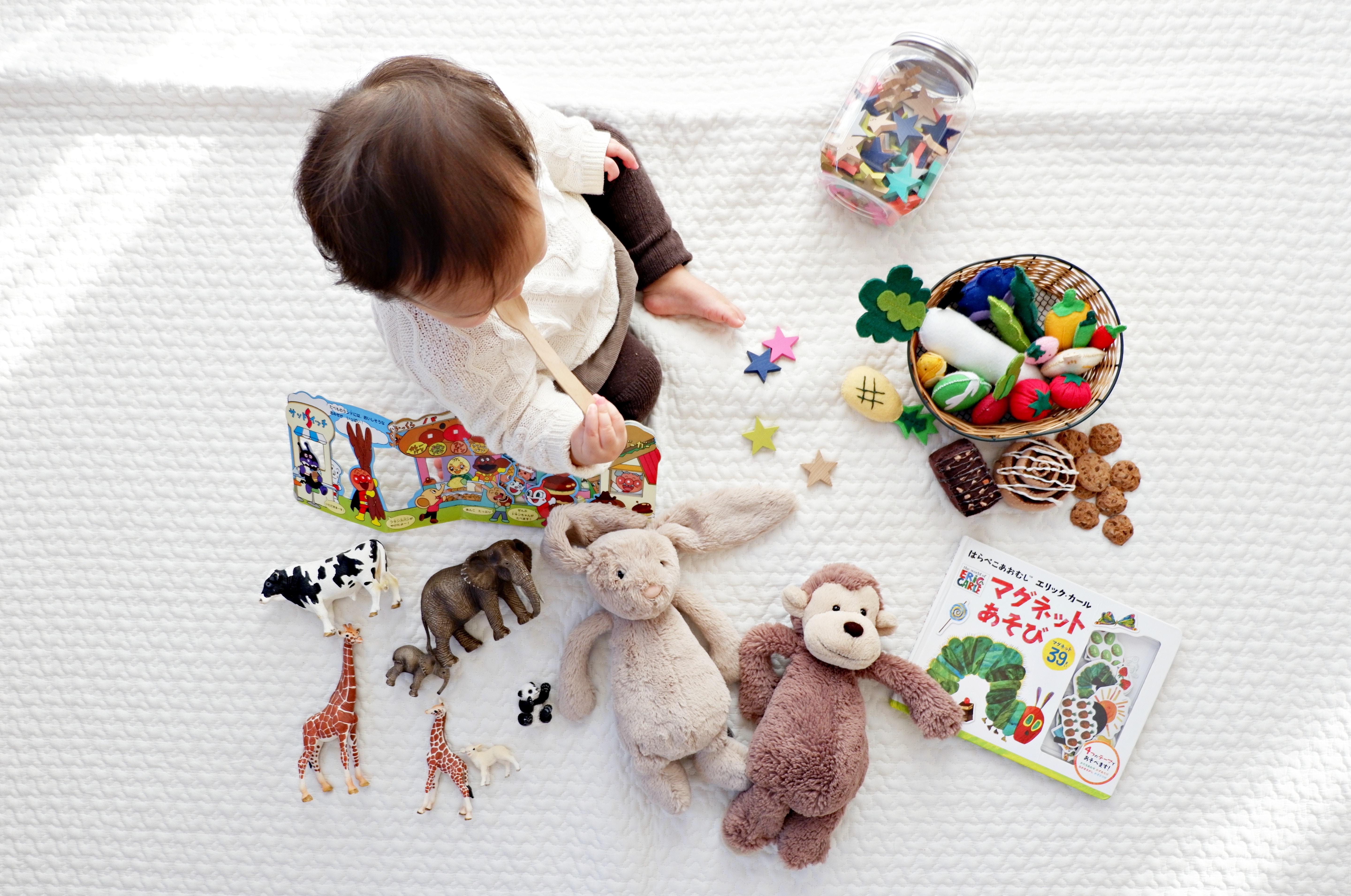 Baby playing with toys and books HD Wallpaper