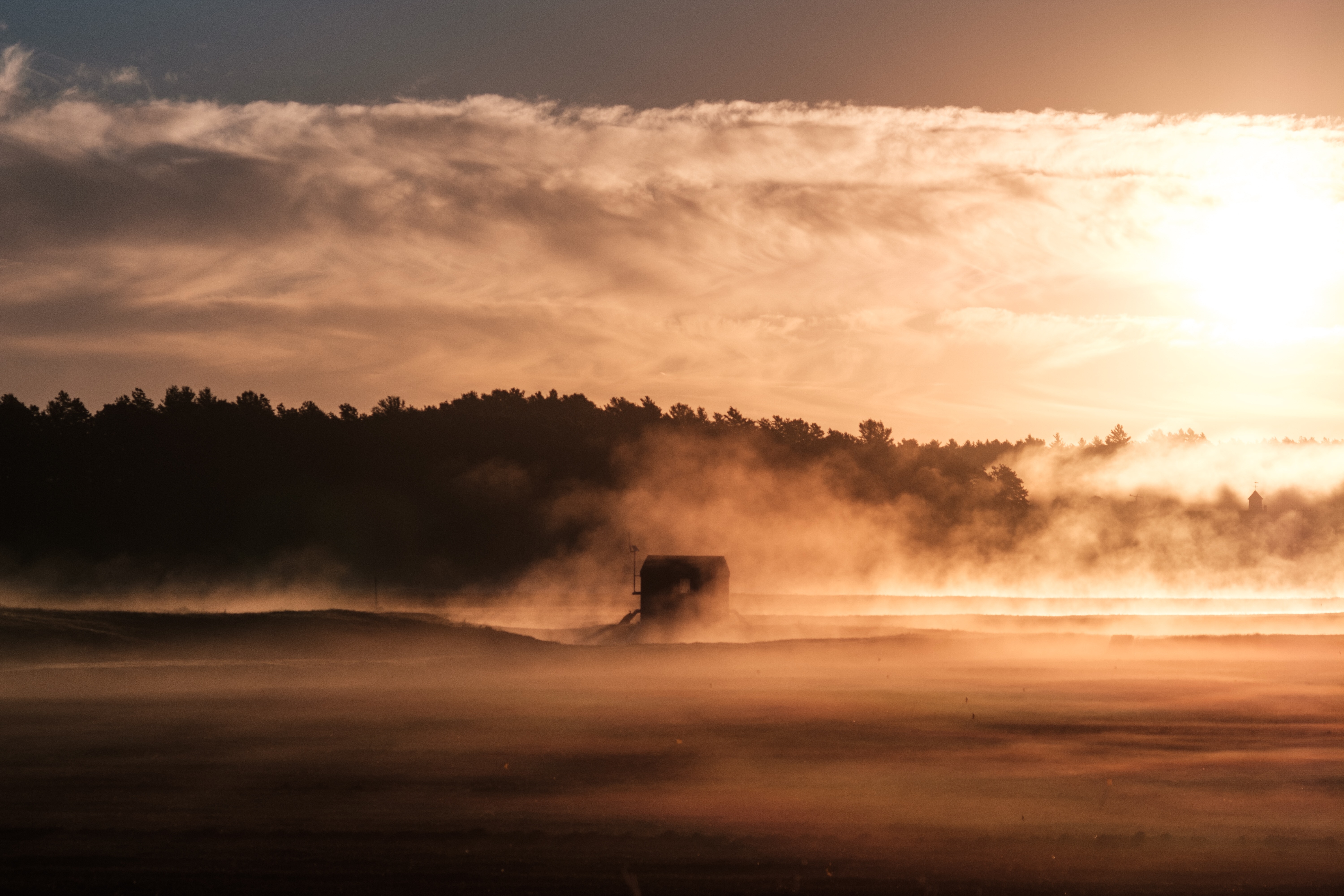 Misty morning with a silhouette of a structure HD Wallpaper