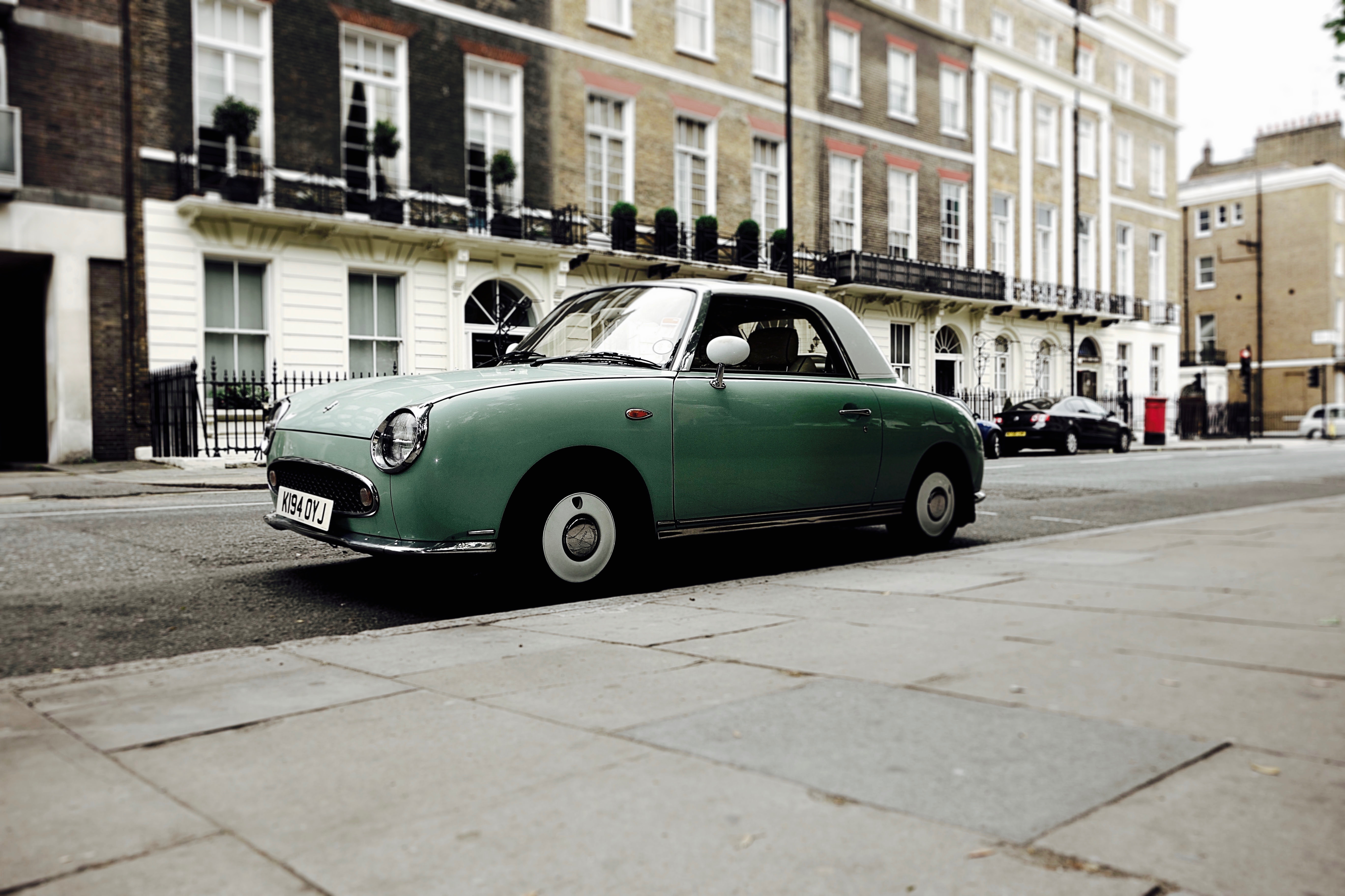 Vintage turquoise Nissan Figaro parked on a London street HD Wallpaper