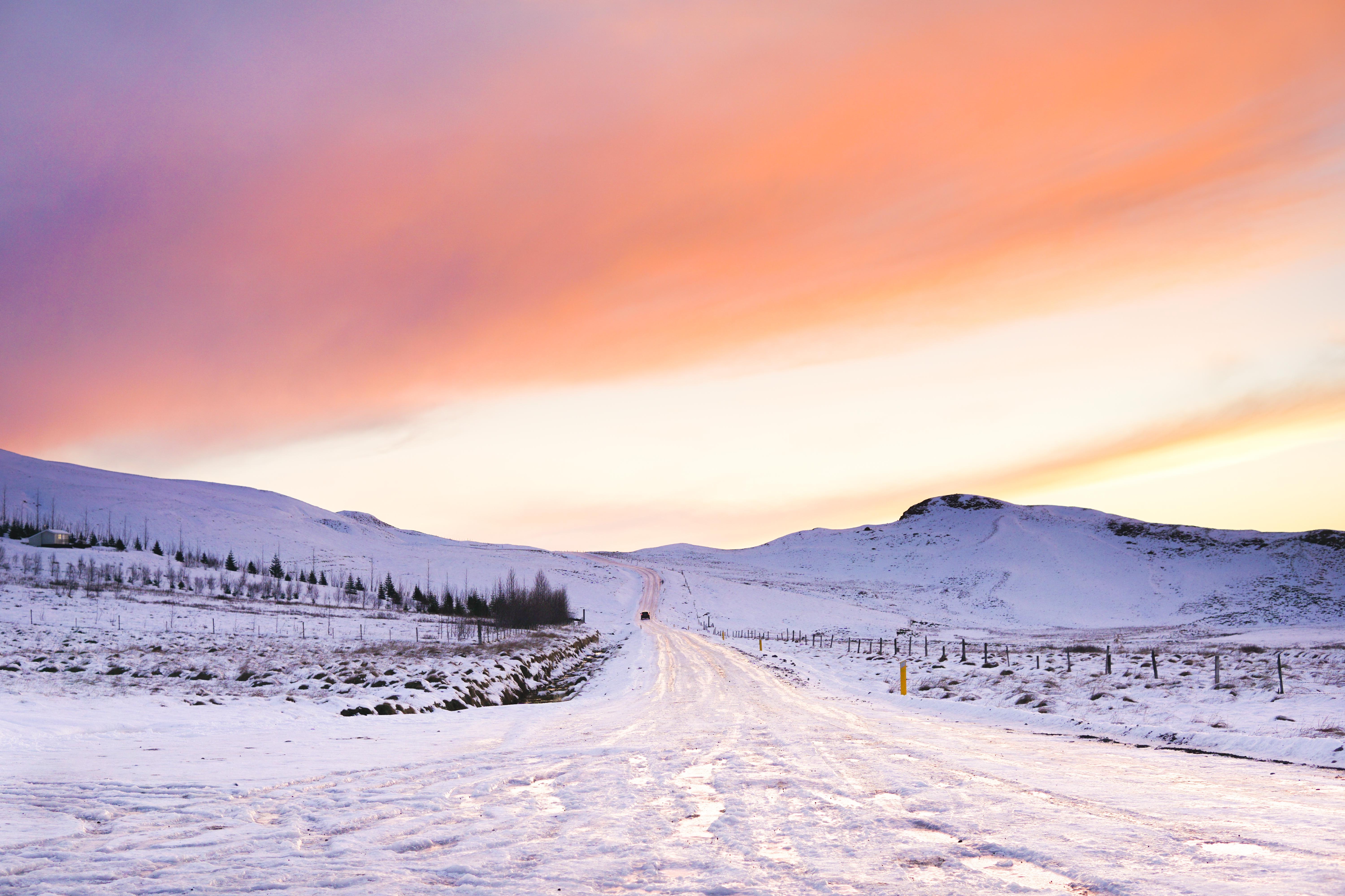 Snowy road in Iceland during sunrise or sunset HD Wallpaper