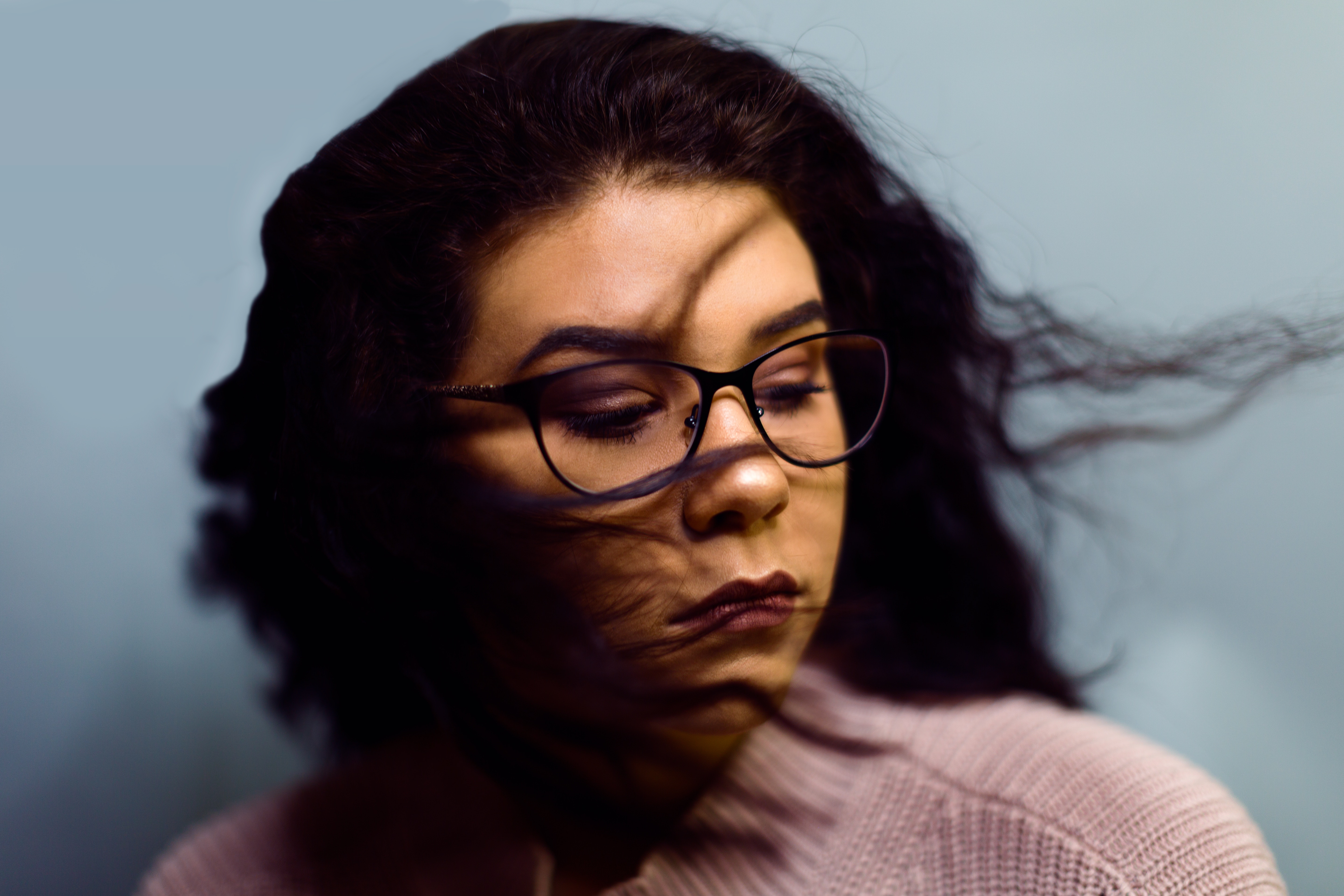 Woman with glasses and hair blowing in the wind HD Wallpaper
