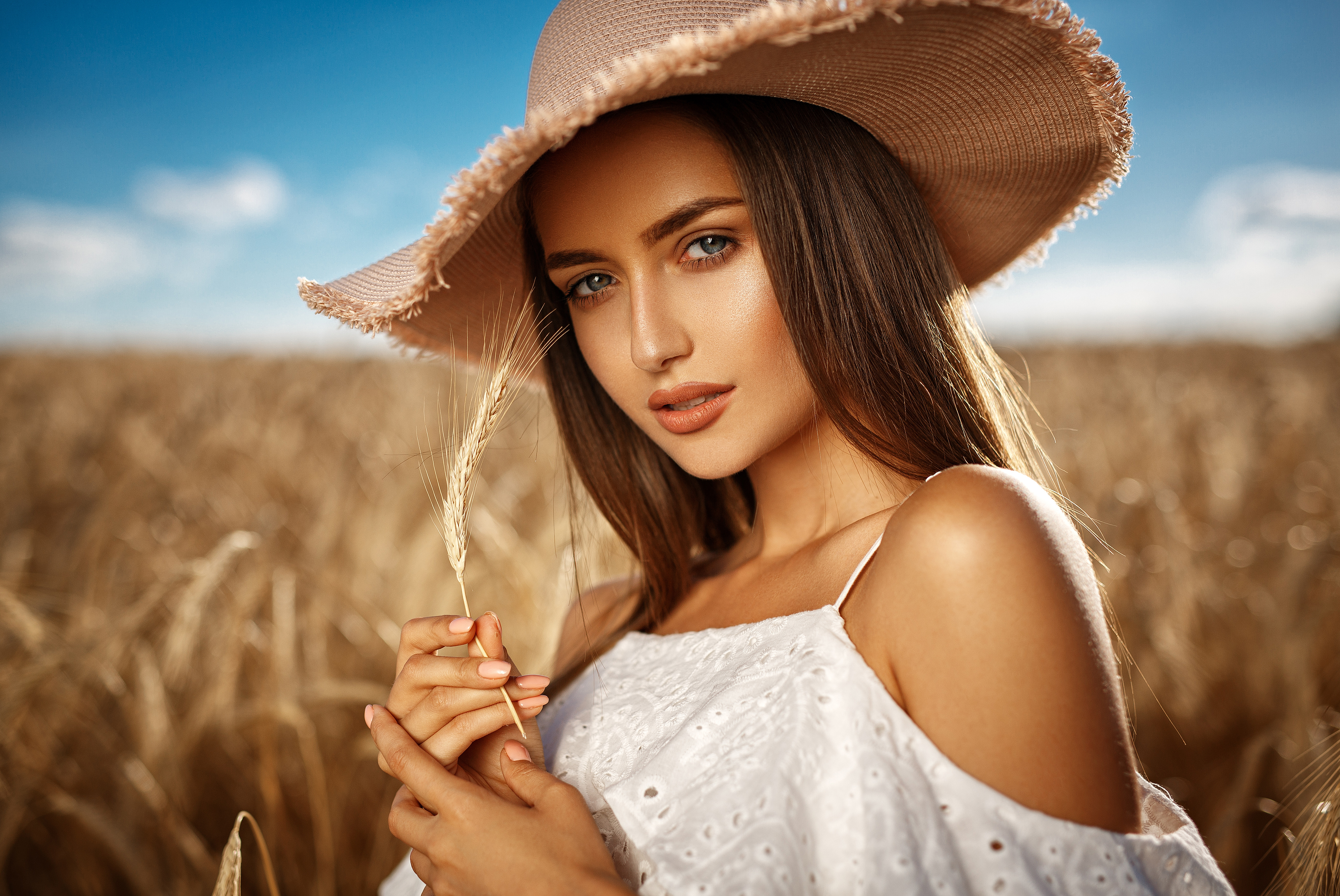 Woman in a hat in a wheat field HD Wallpaper