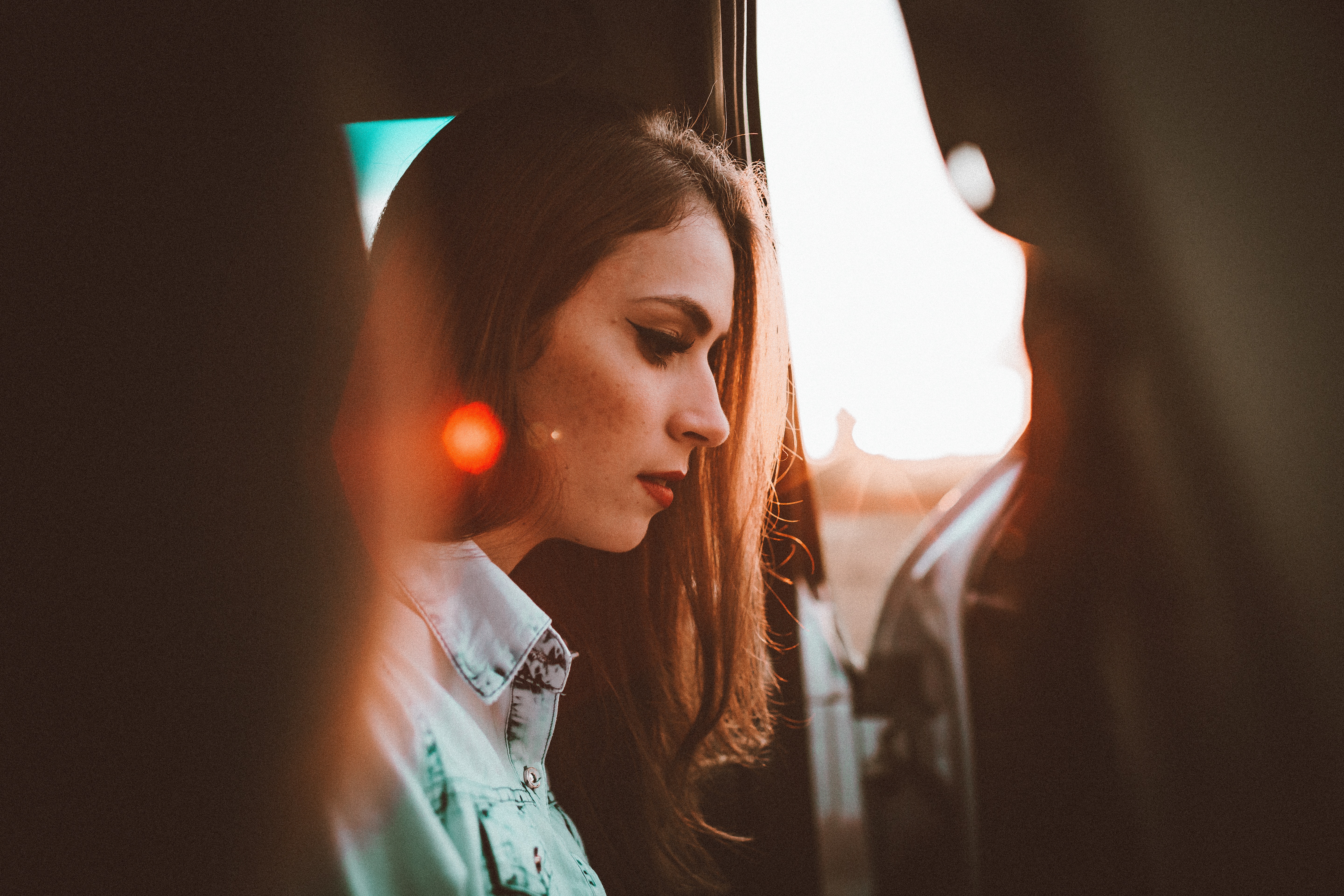 Woman in car during golden hour with sun flare HD Wallpaper