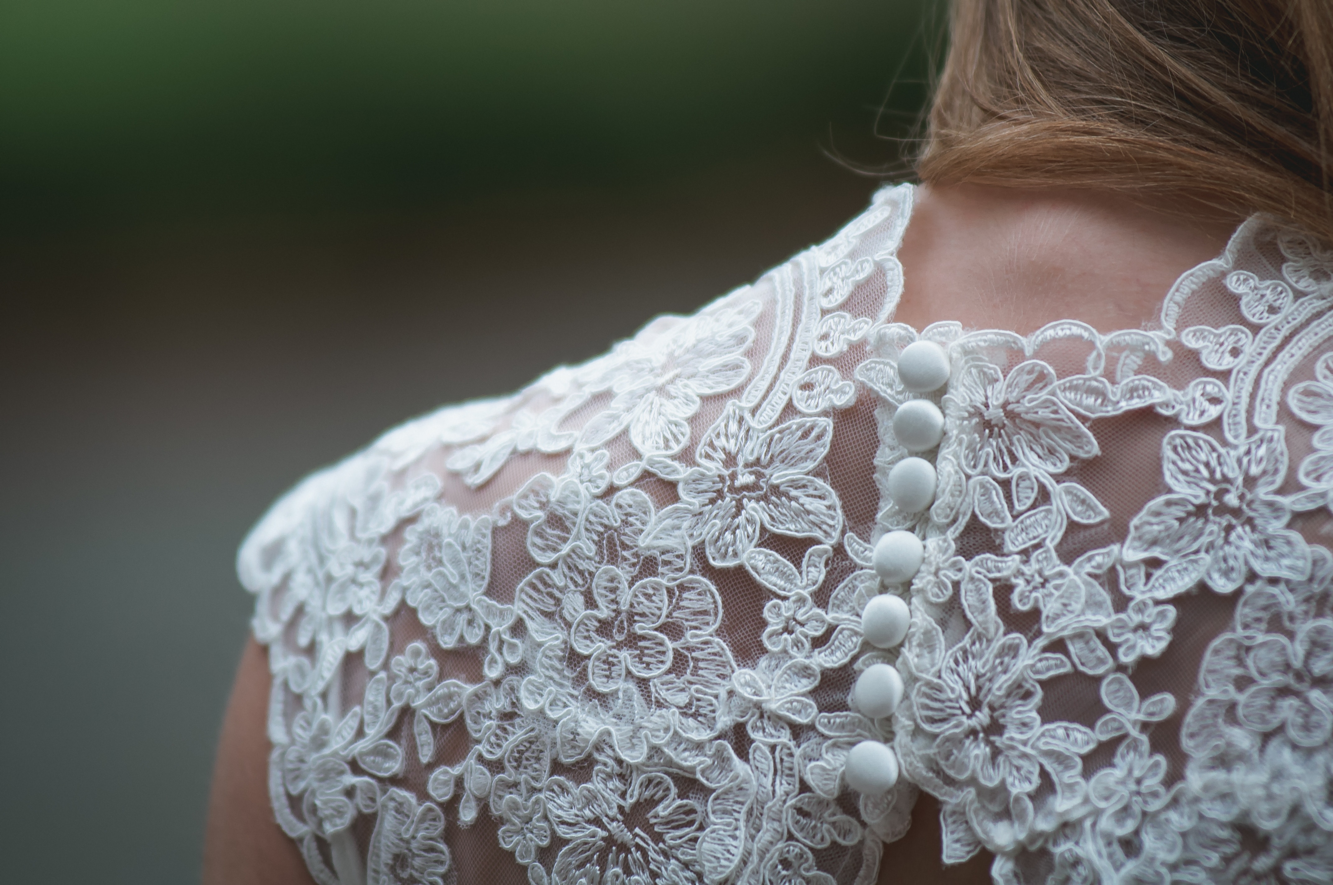 Close-up of a white lace wedding dress with buttons HD Wallpaper