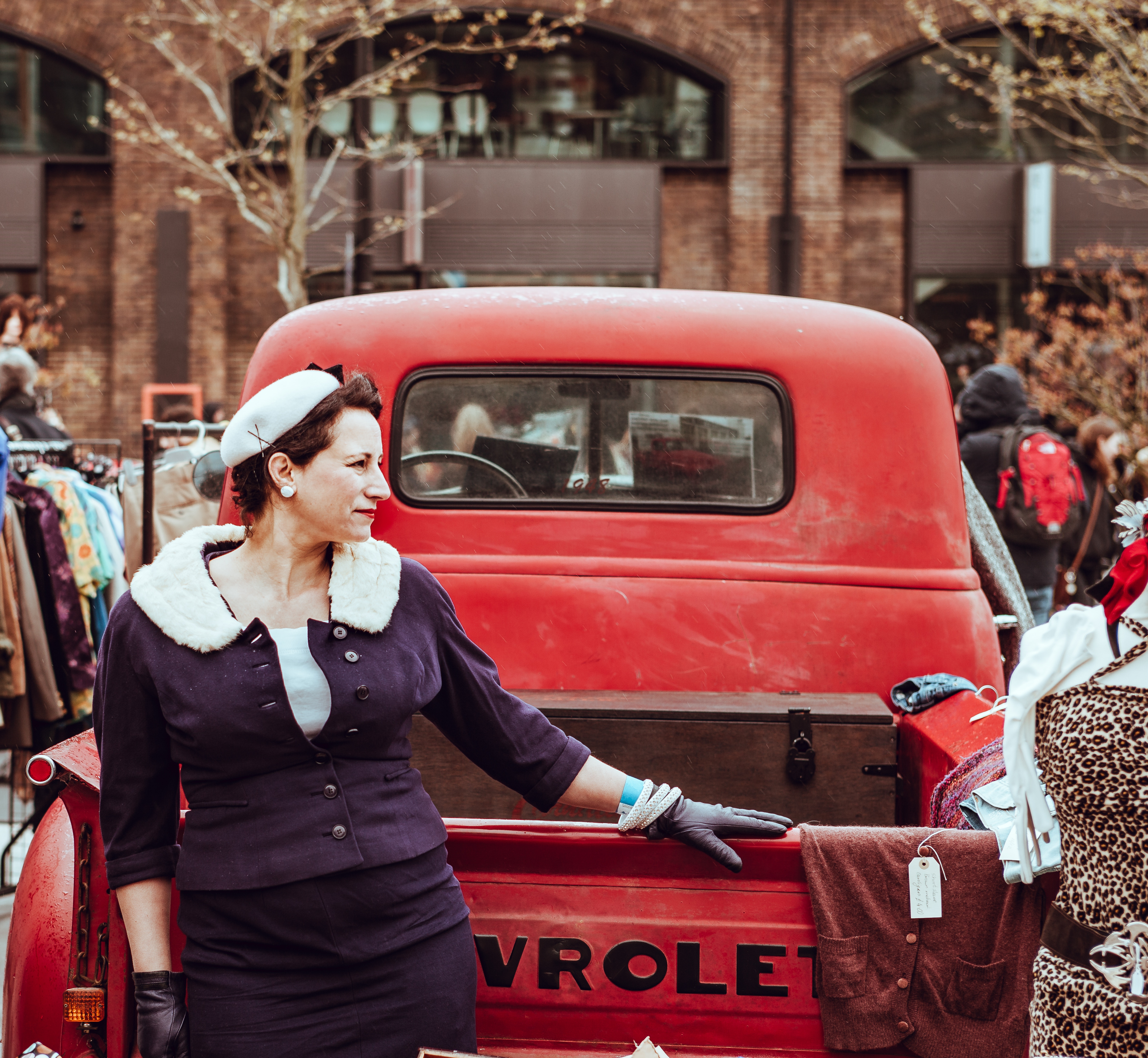 Woman in vintage clothing at a Chevrolet car boot sale HD Wallpaper