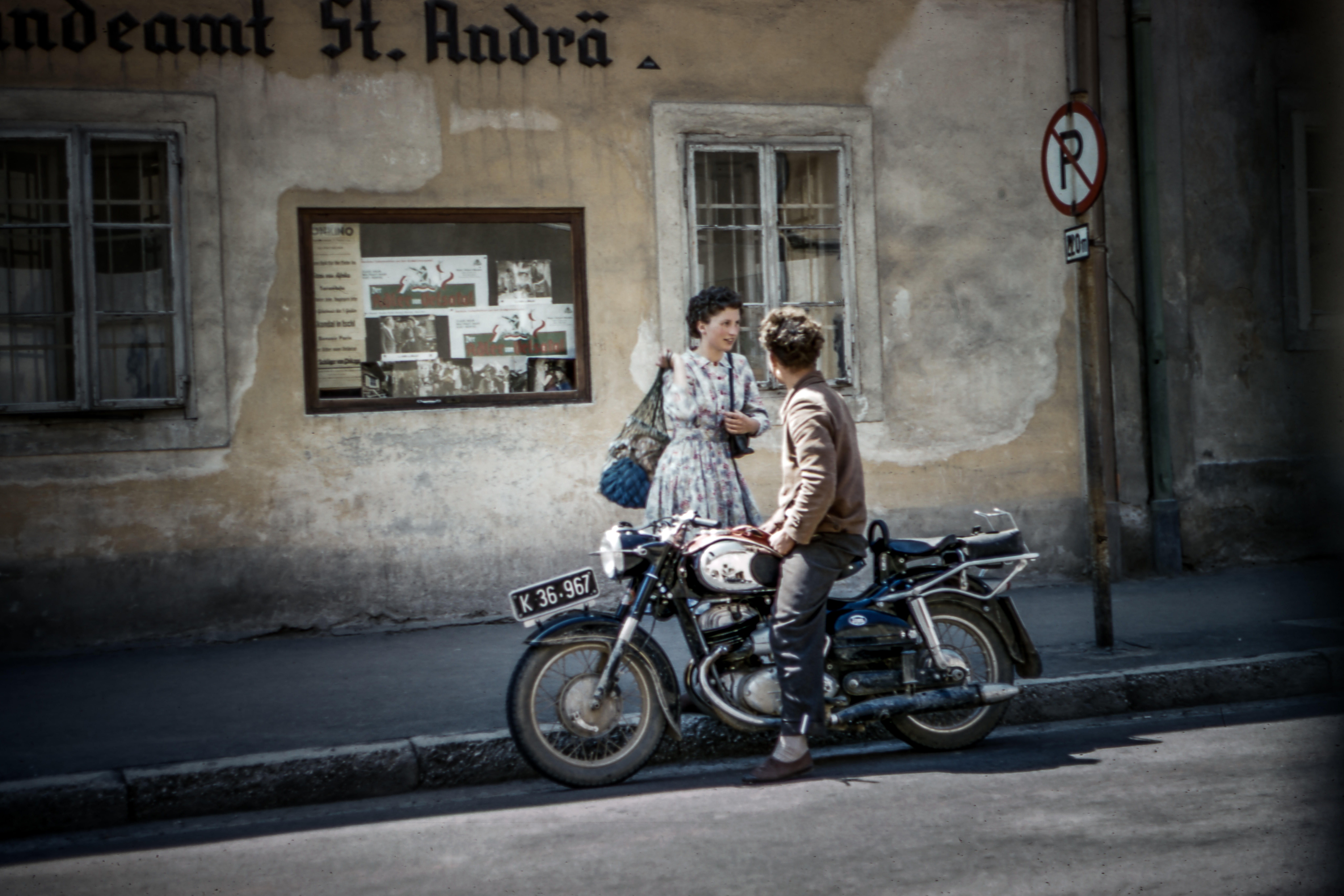 Man and woman talking by a motorcycle HD Wallpaper