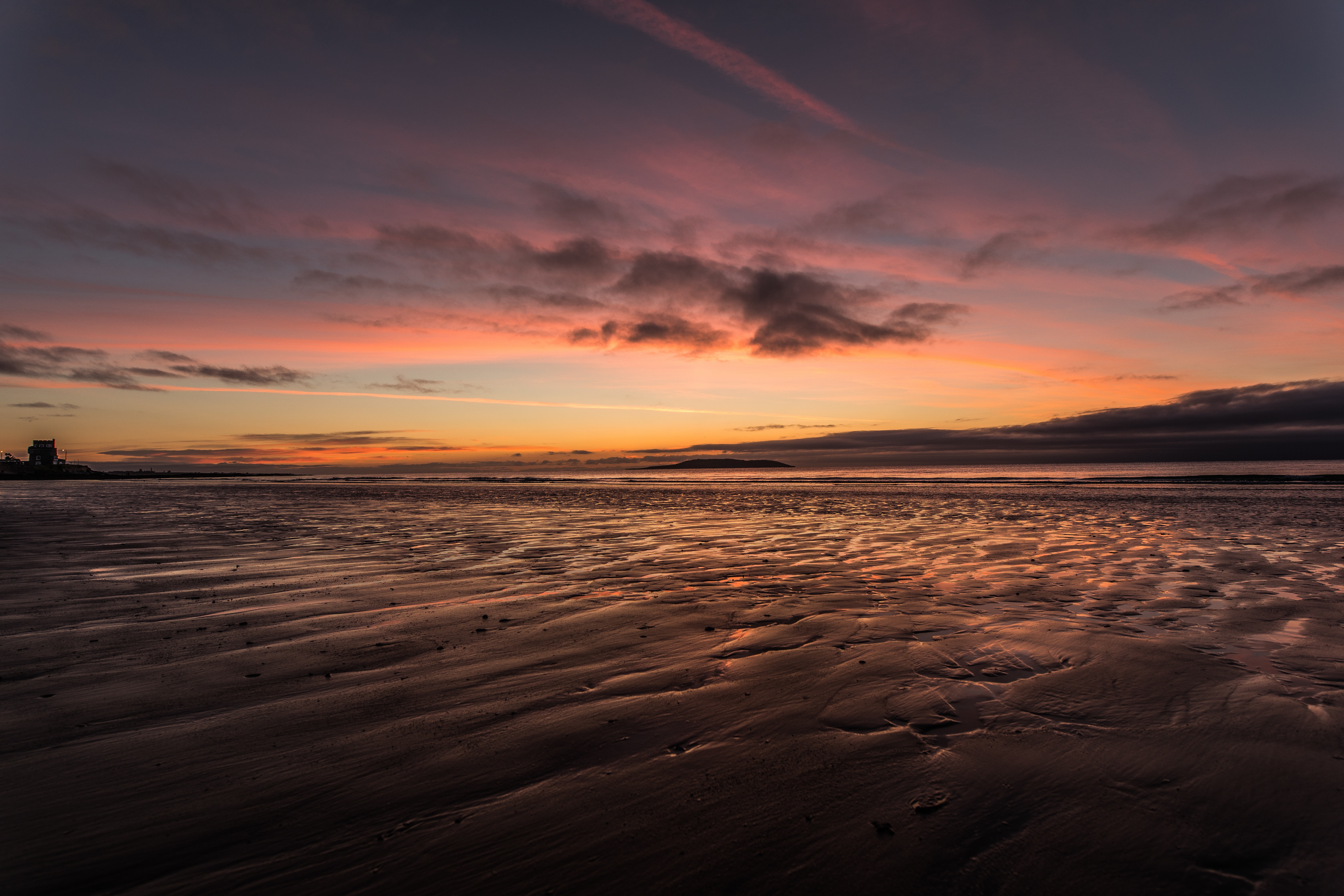 Beach at sunrise with colorful clouds and wet sand HD Wallpaper