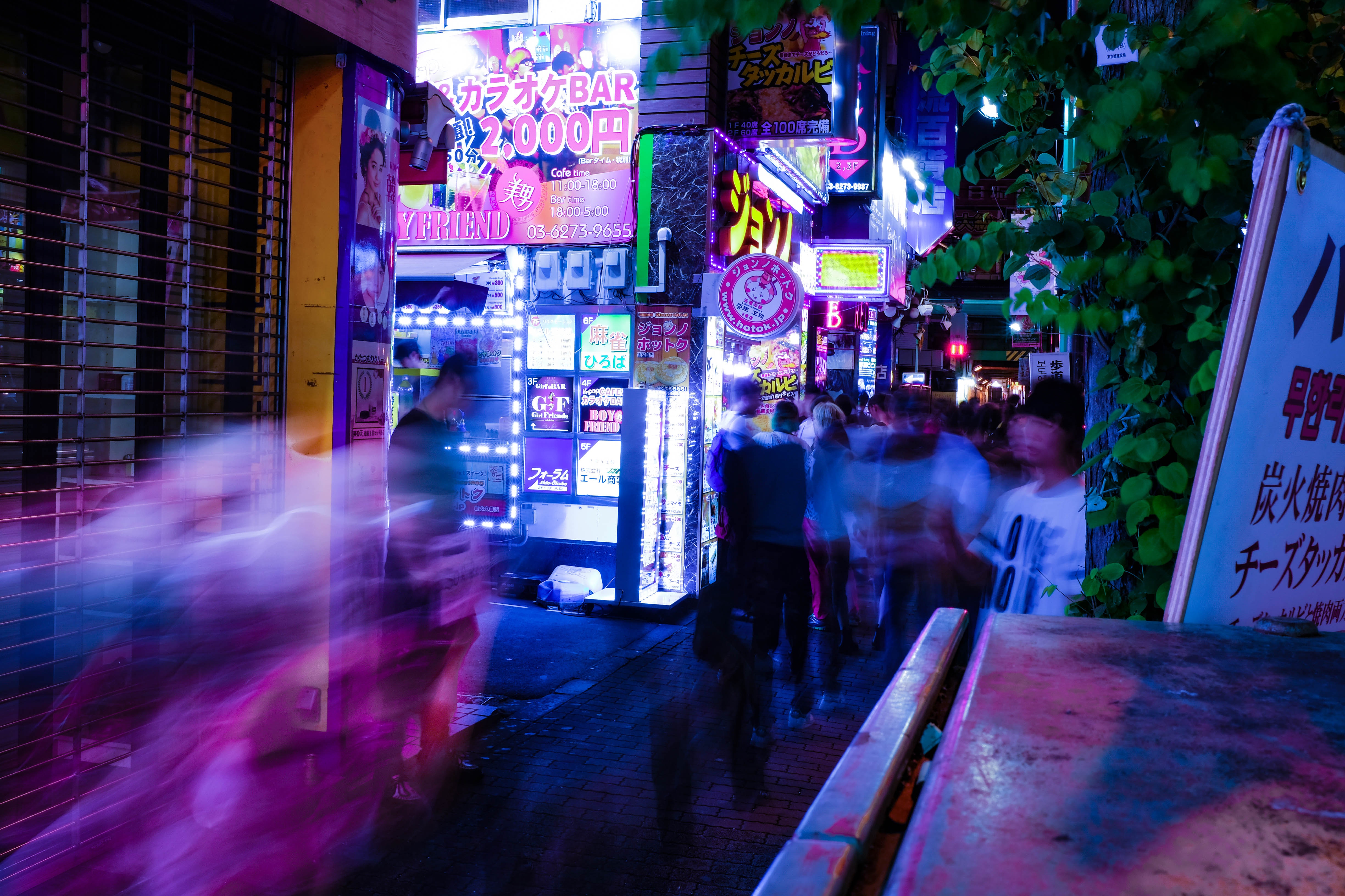 Night street with neon signs and people HD Wallpaper