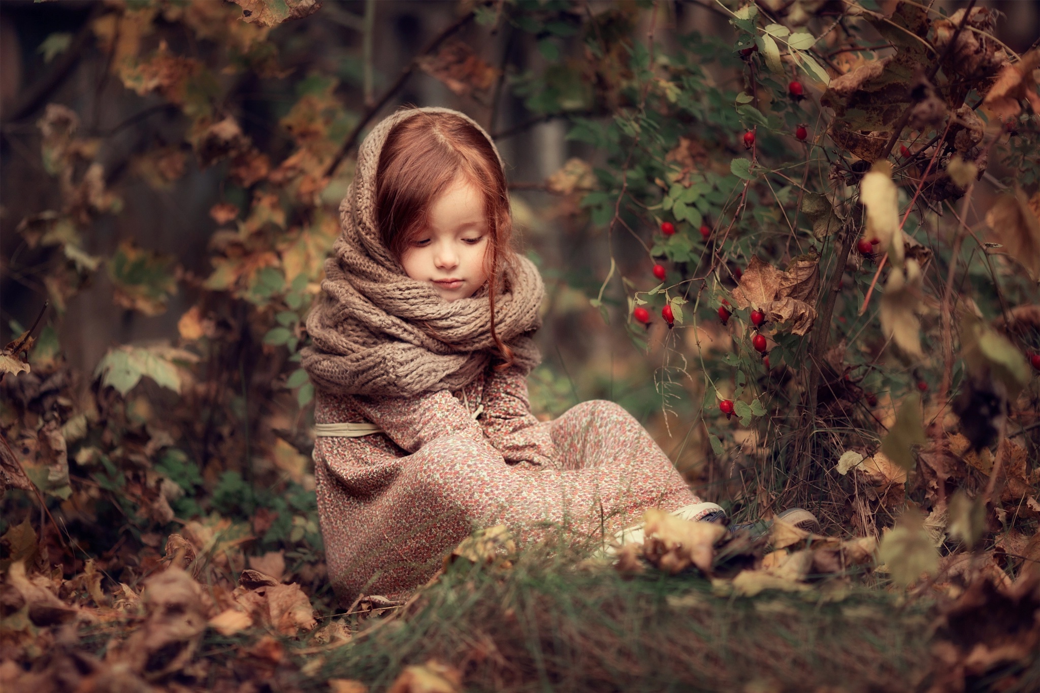 Little redhead girl in a scarf sitting in autumn forest HD Wallpaper