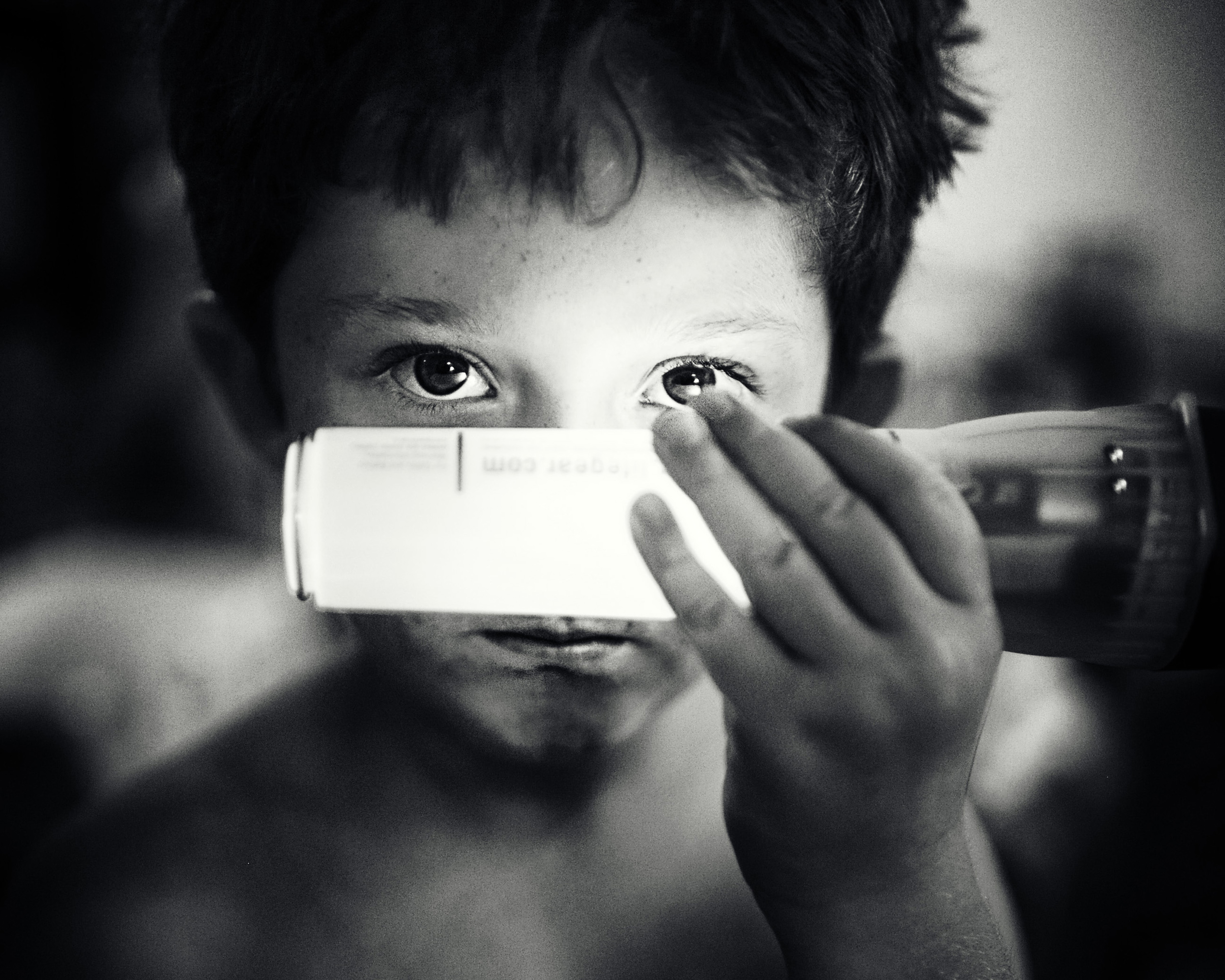 Boy holding a glow stick to his eye HD Wallpaper
