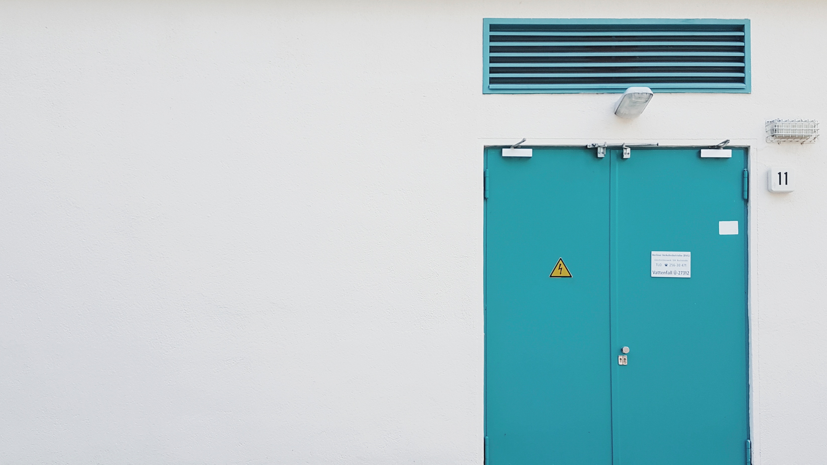 Teal double doors on a white wall with a vent HD Wallpaper
