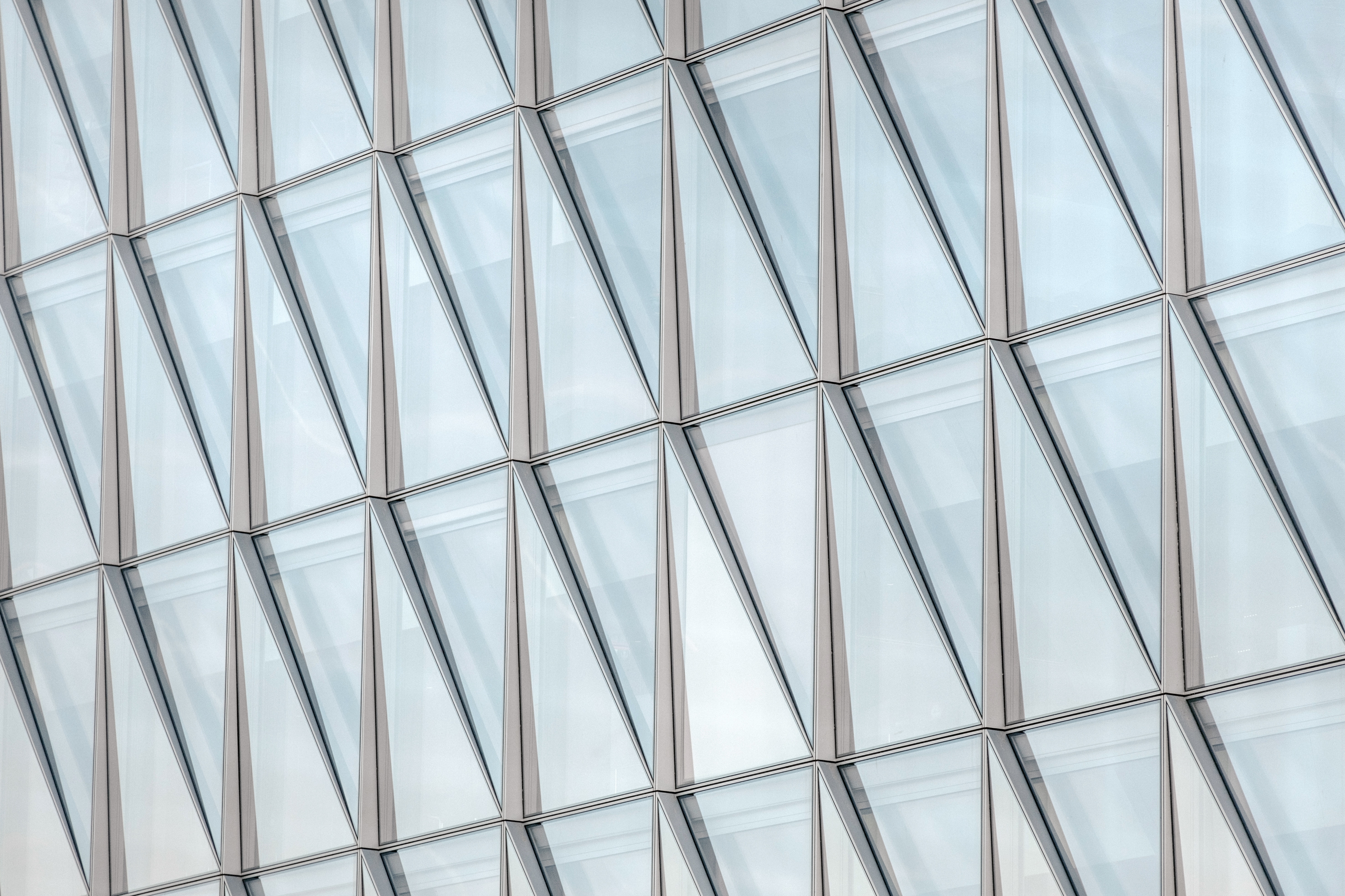 Geometric facade with triangular glass windows HD Wallpaper