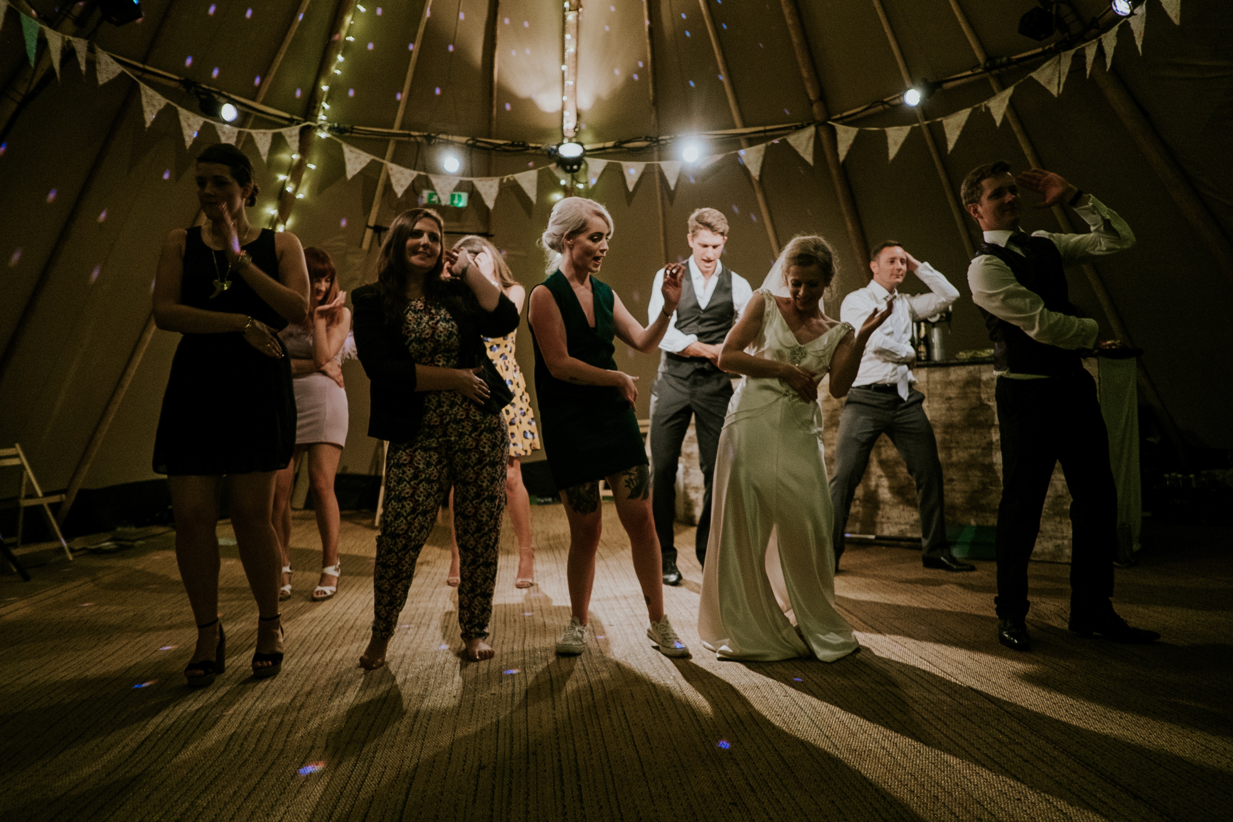 People dancing at a wedding reception in a tent HD Wallpaper