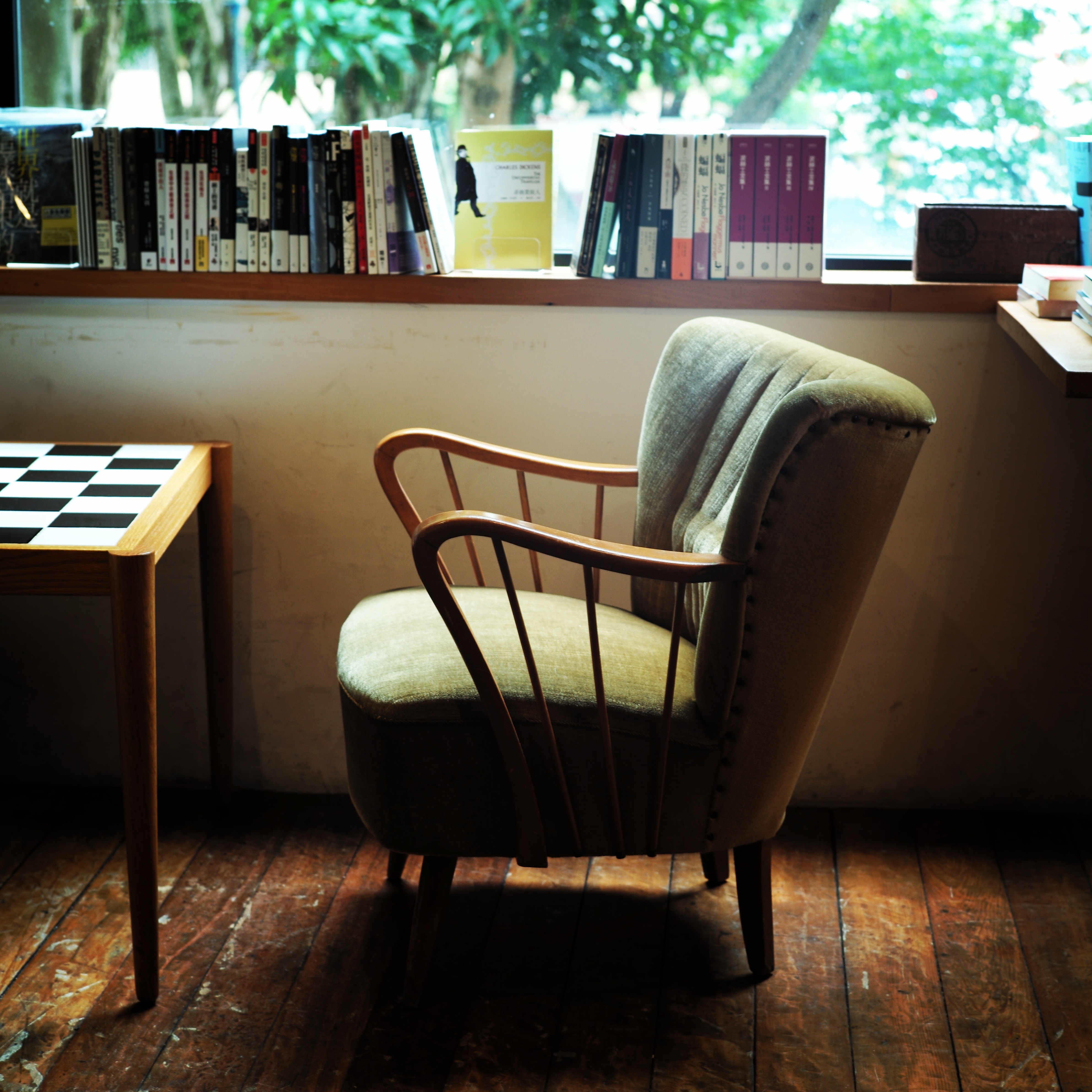 Green armchair and books by the window HD Wallpaper