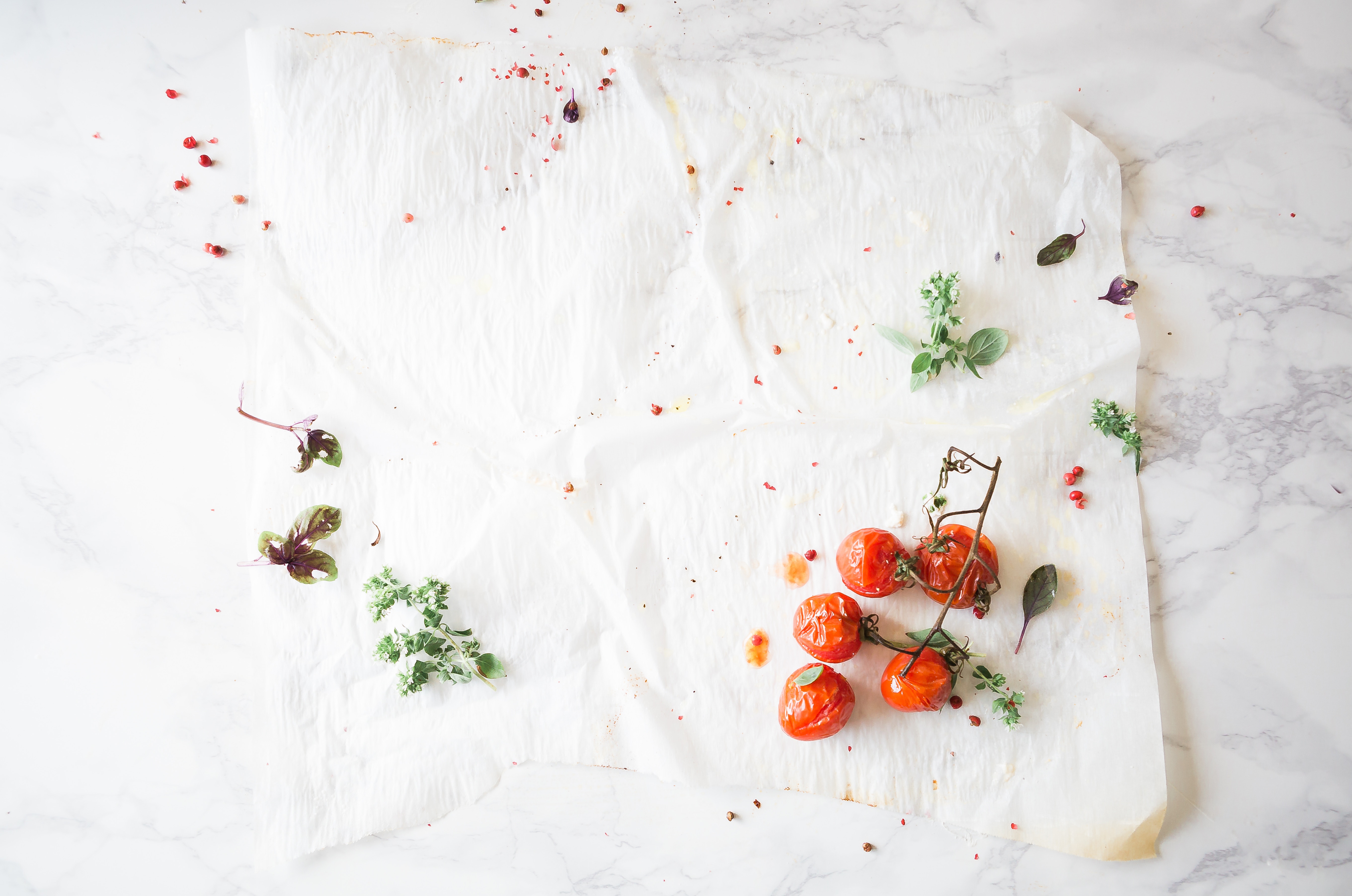 Roasted cherry tomatoes with herbs on baking paper HD Wallpaper