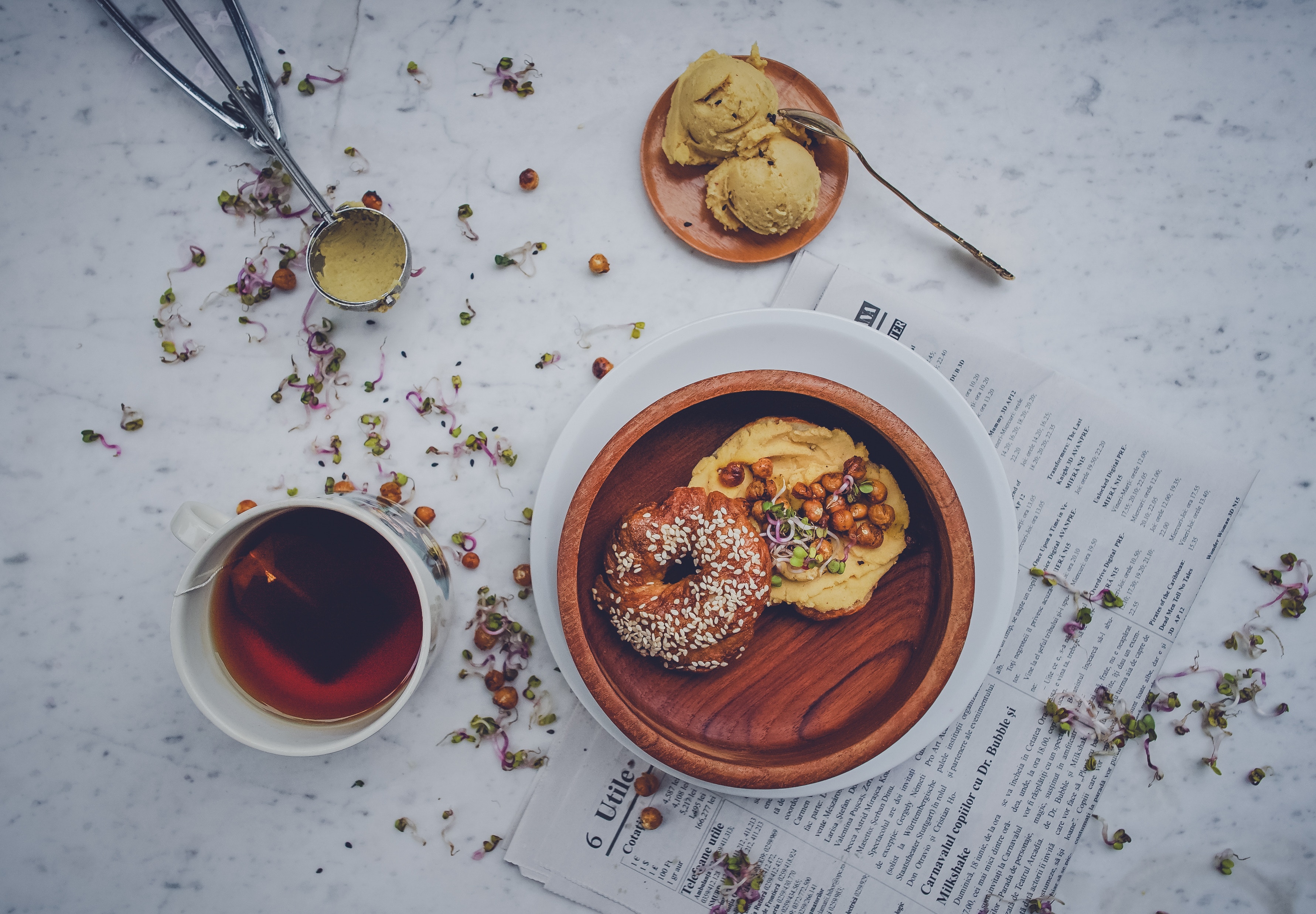 Bagel with hummus and tea on a marble table HD Wallpaper