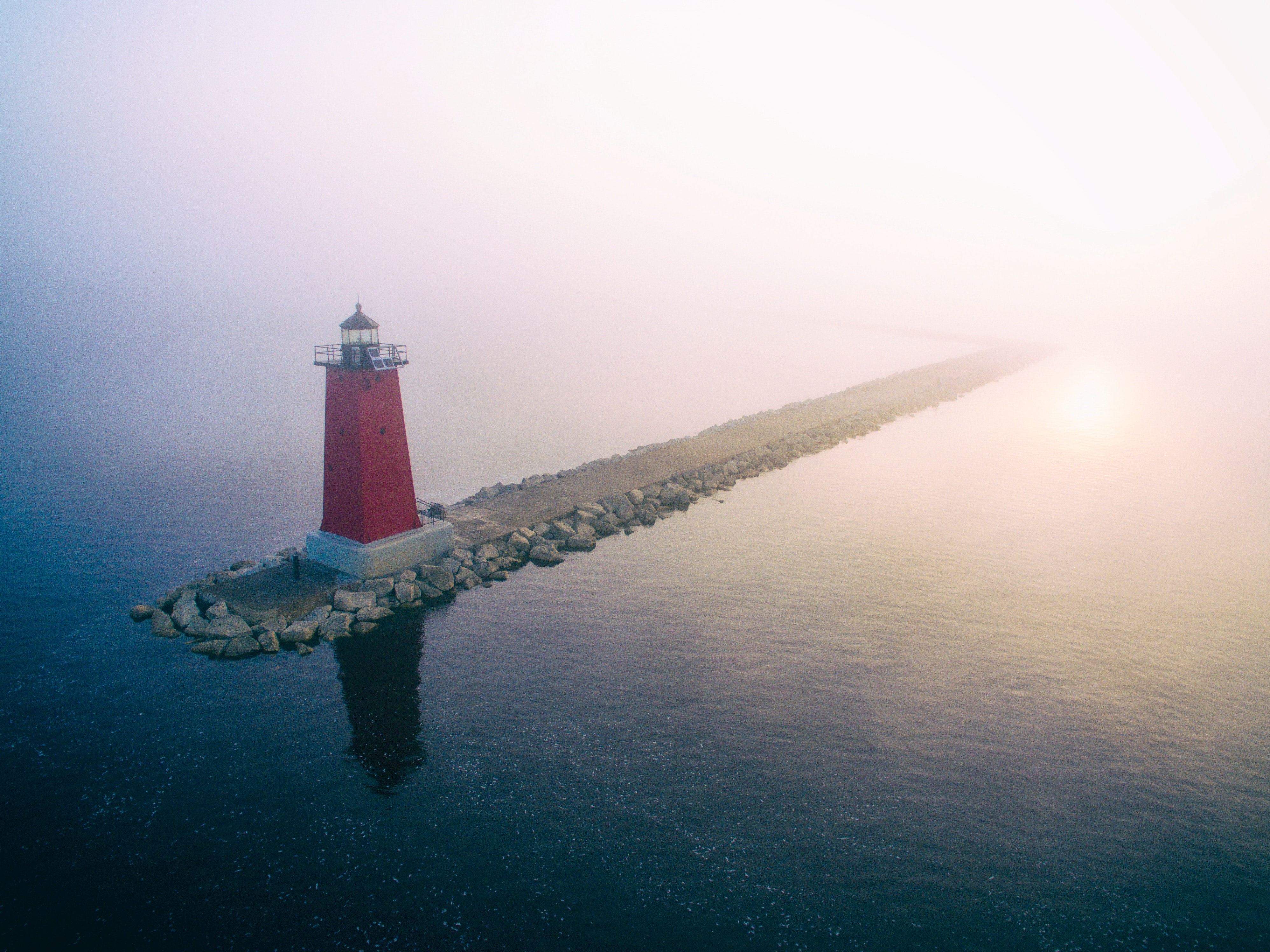 Red lighthouse on a breakwater in the fog HD Wallpaper