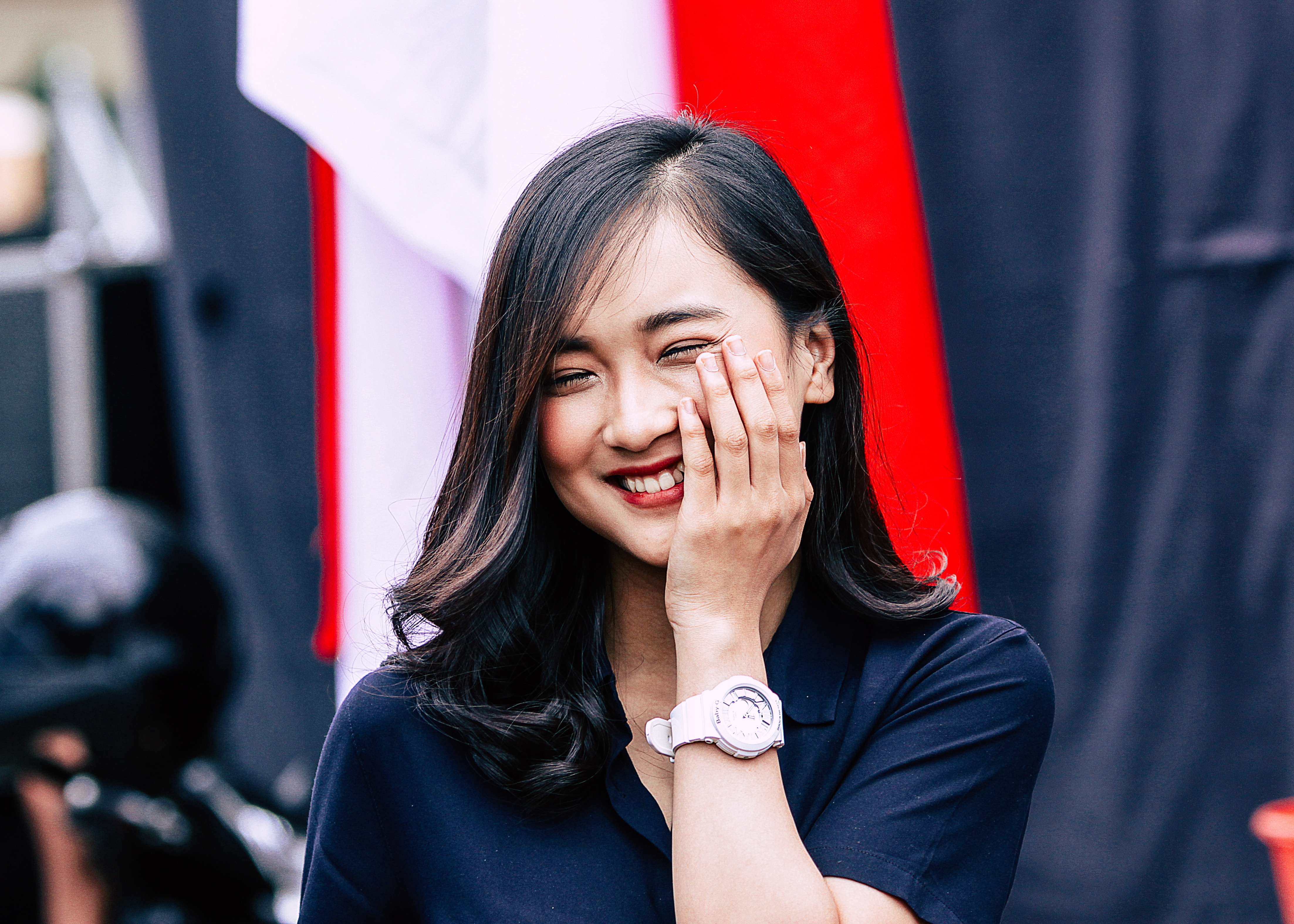 Young woman smiling with hand on face HD Wallpaper