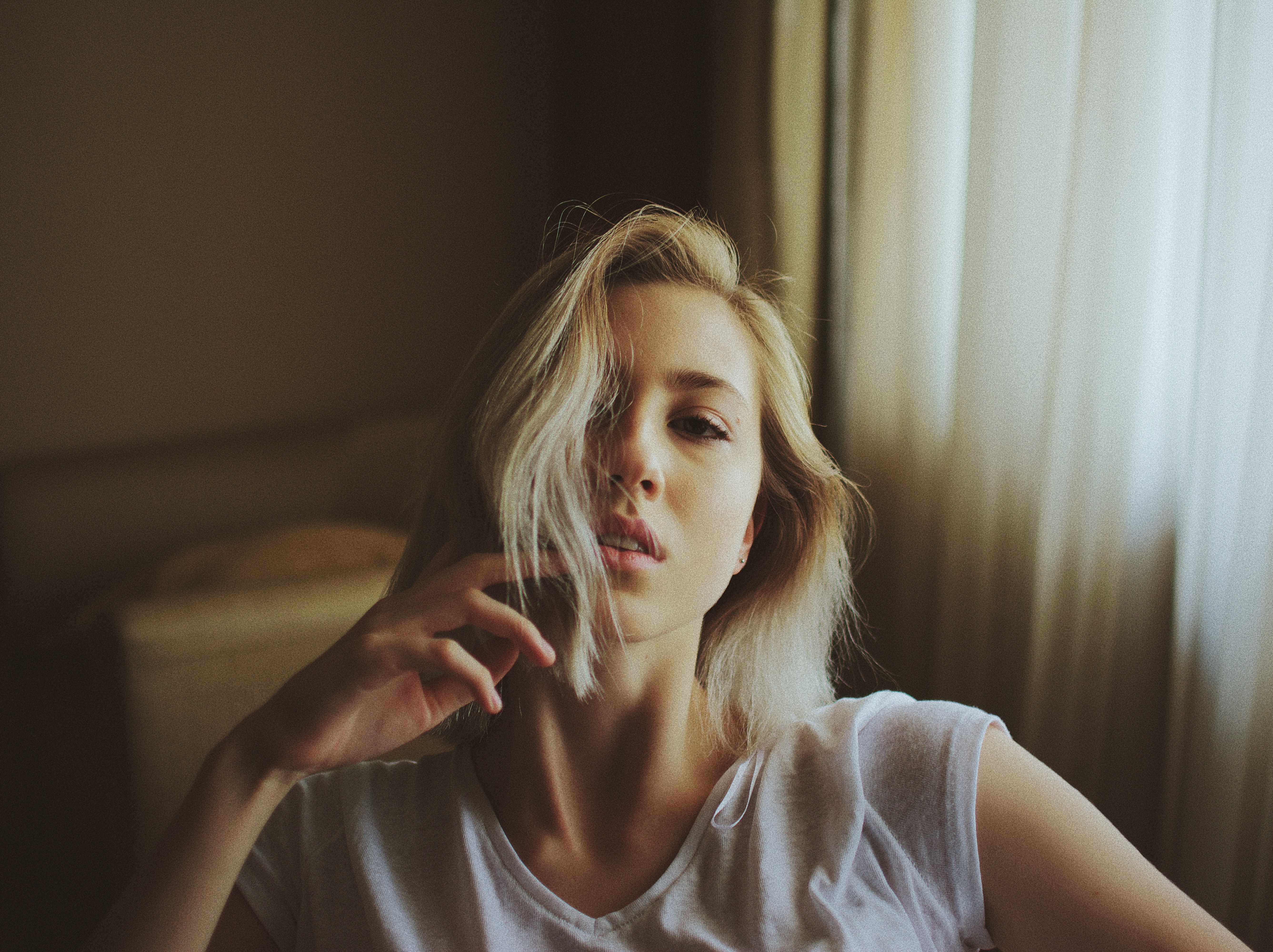 Woman in a white t-shirt sitting indoors HD Wallpaper