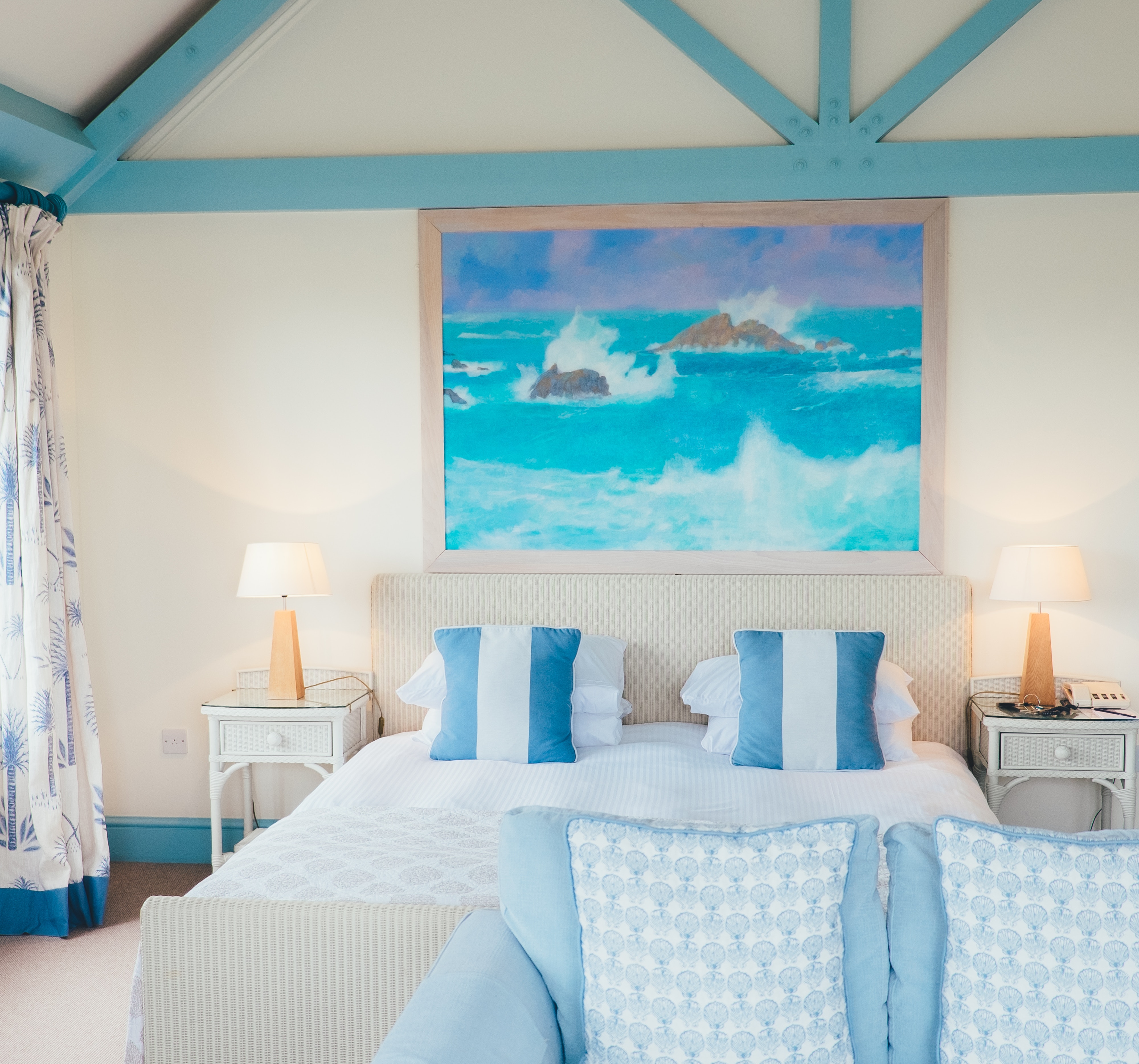 Coastal bedroom with ocean painting and blue accents HD Wallpaper