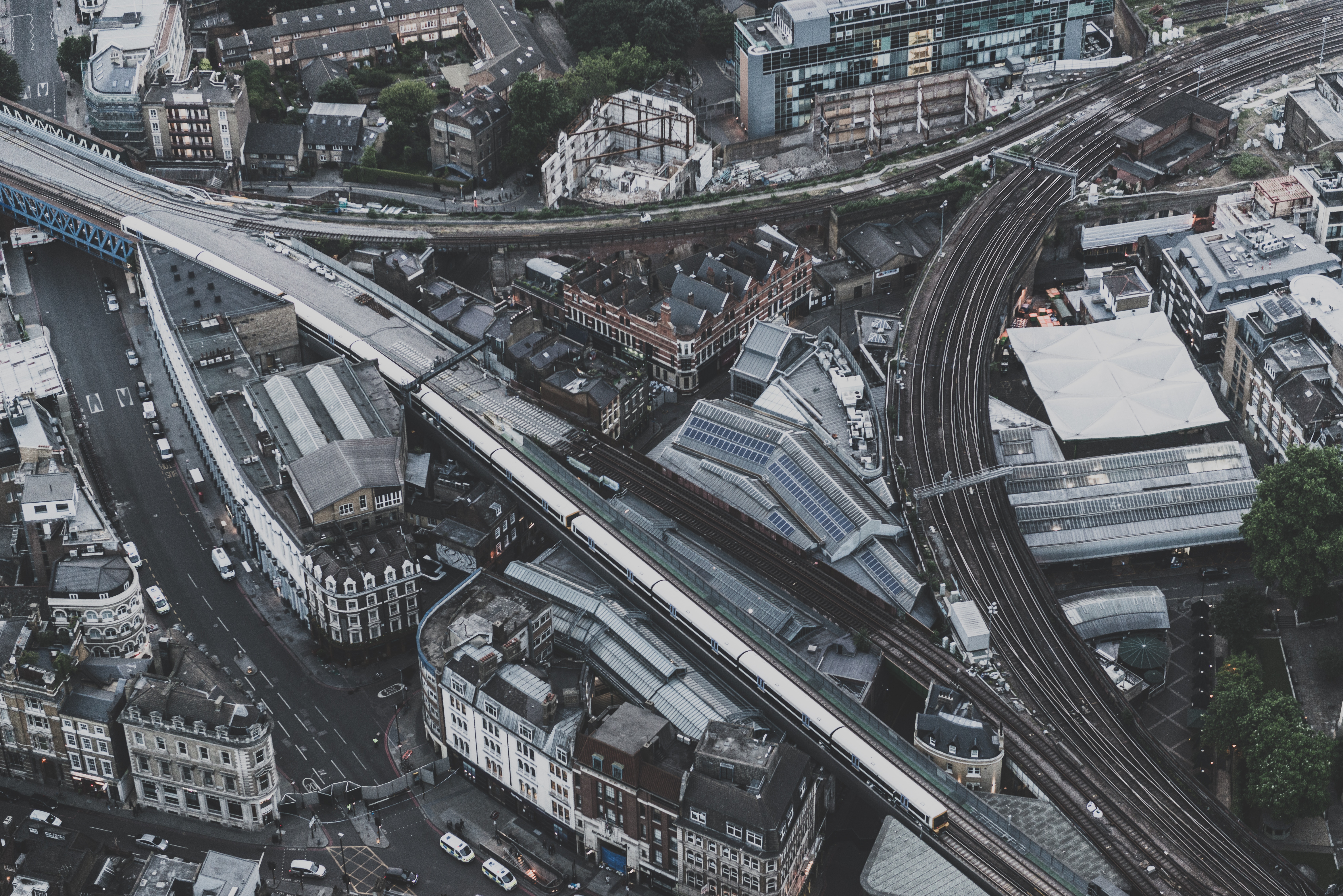 Aerial view of a city with trains and buildings HD Wallpaper