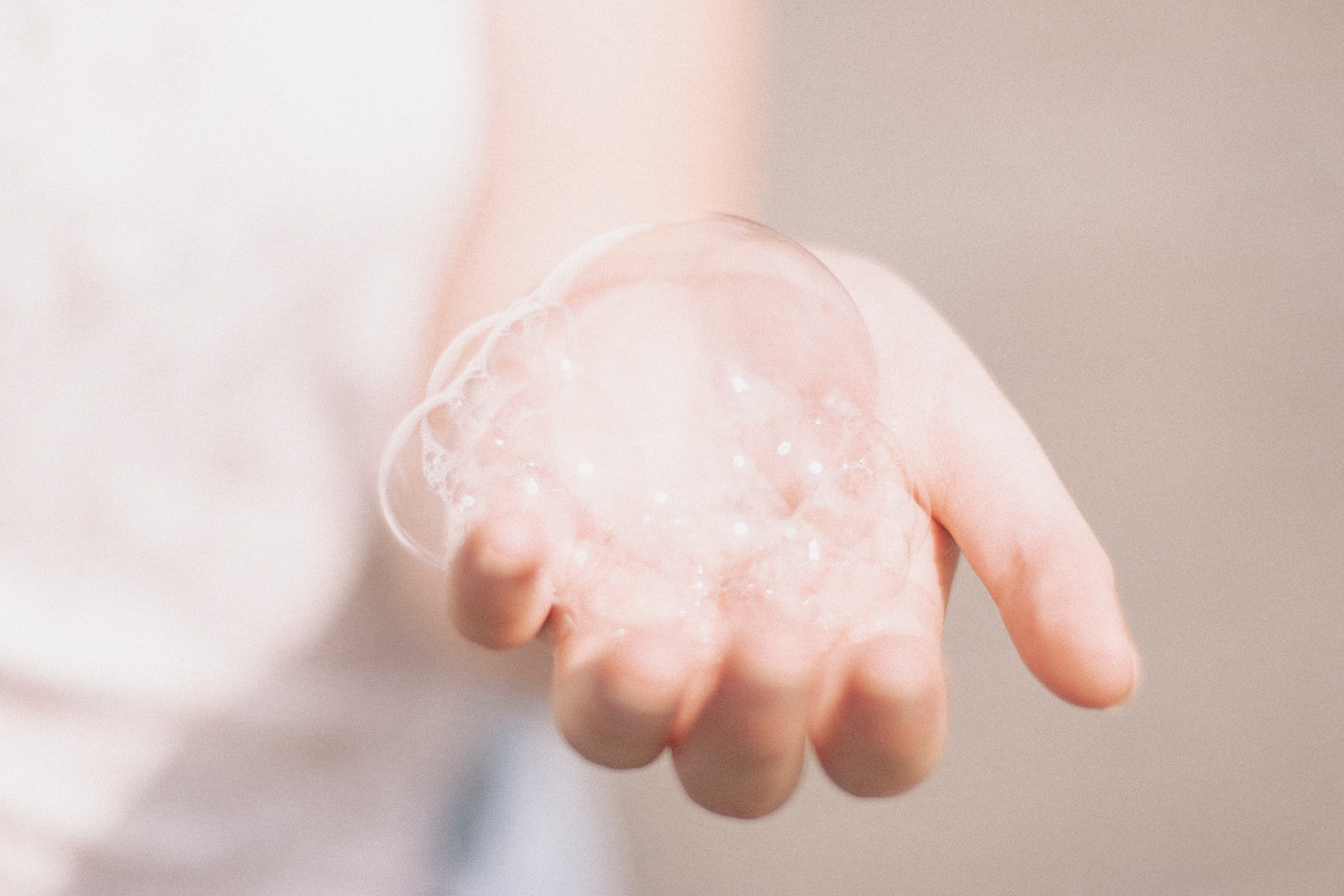 Person holding bubbles in their palm HD Wallpaper