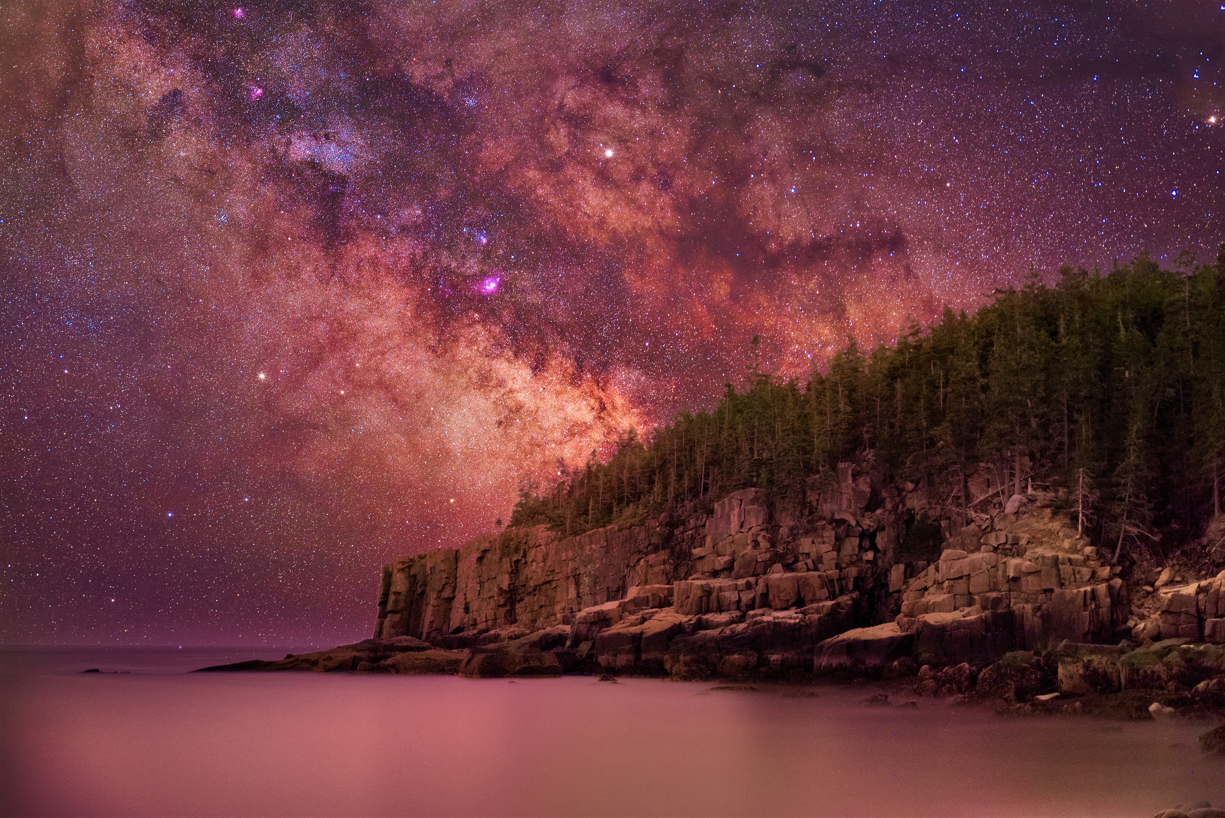 Milky Way over rocky coast and forest at night HD Wallpaper